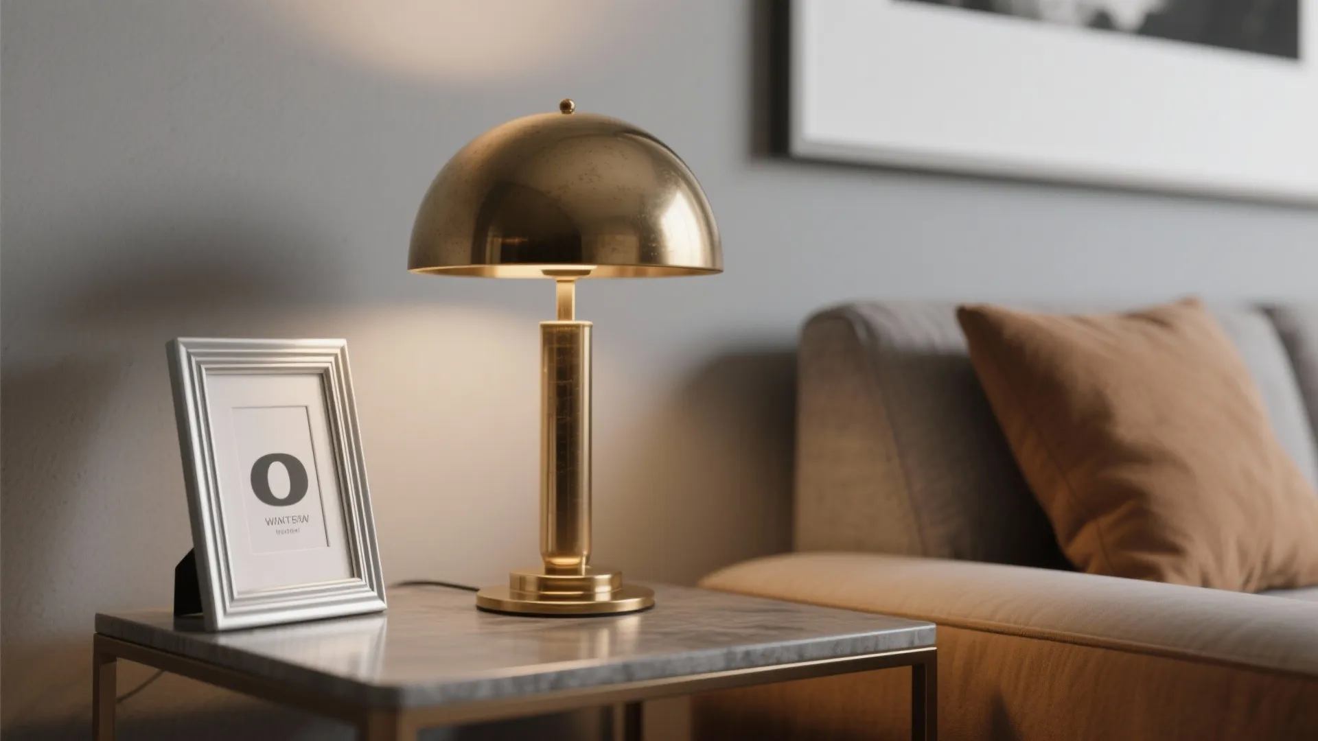 Close-up of brass lamp and silver frame in a living room