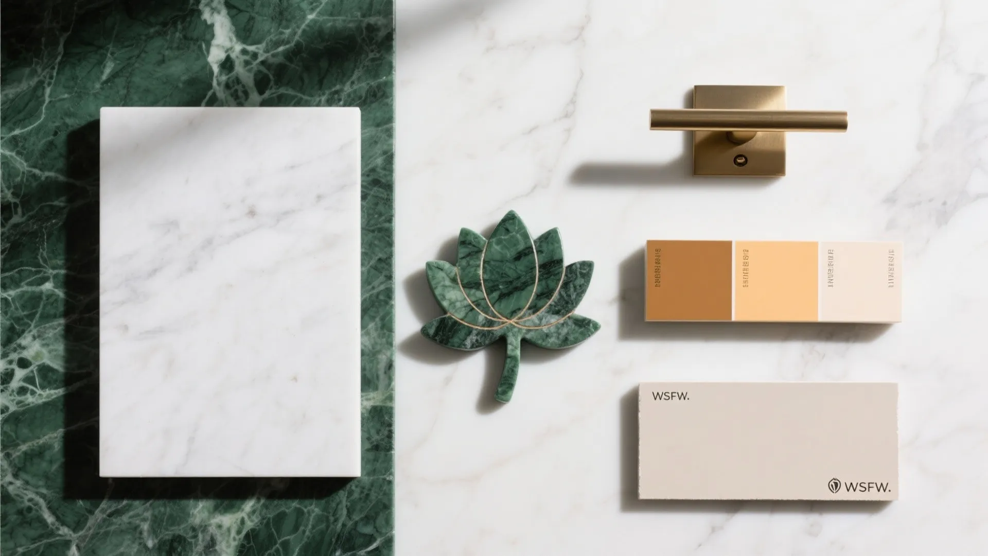 Material board with green marble white marble color samples gold handle and a leaf shape