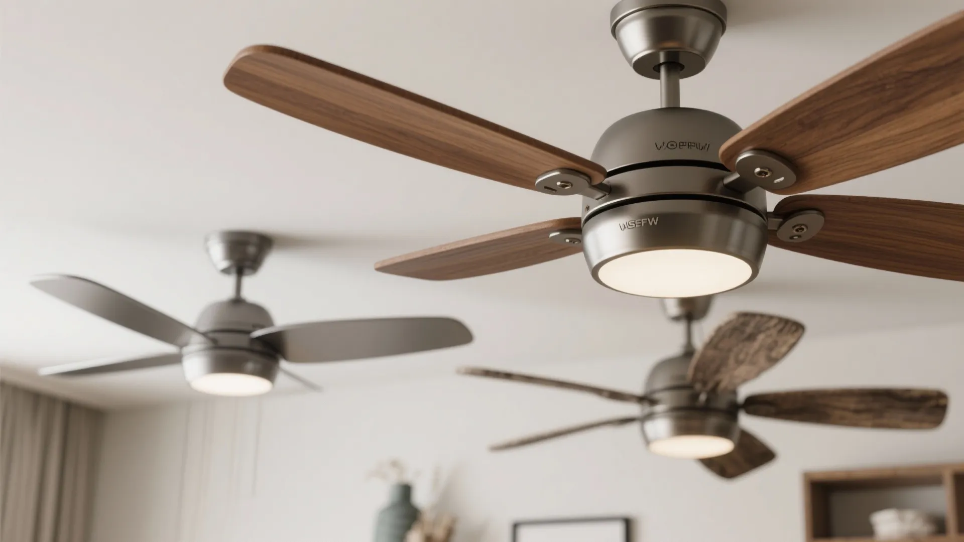 Close-up of two complementary ceiling fan designs with coordinated finish and wood blades.
