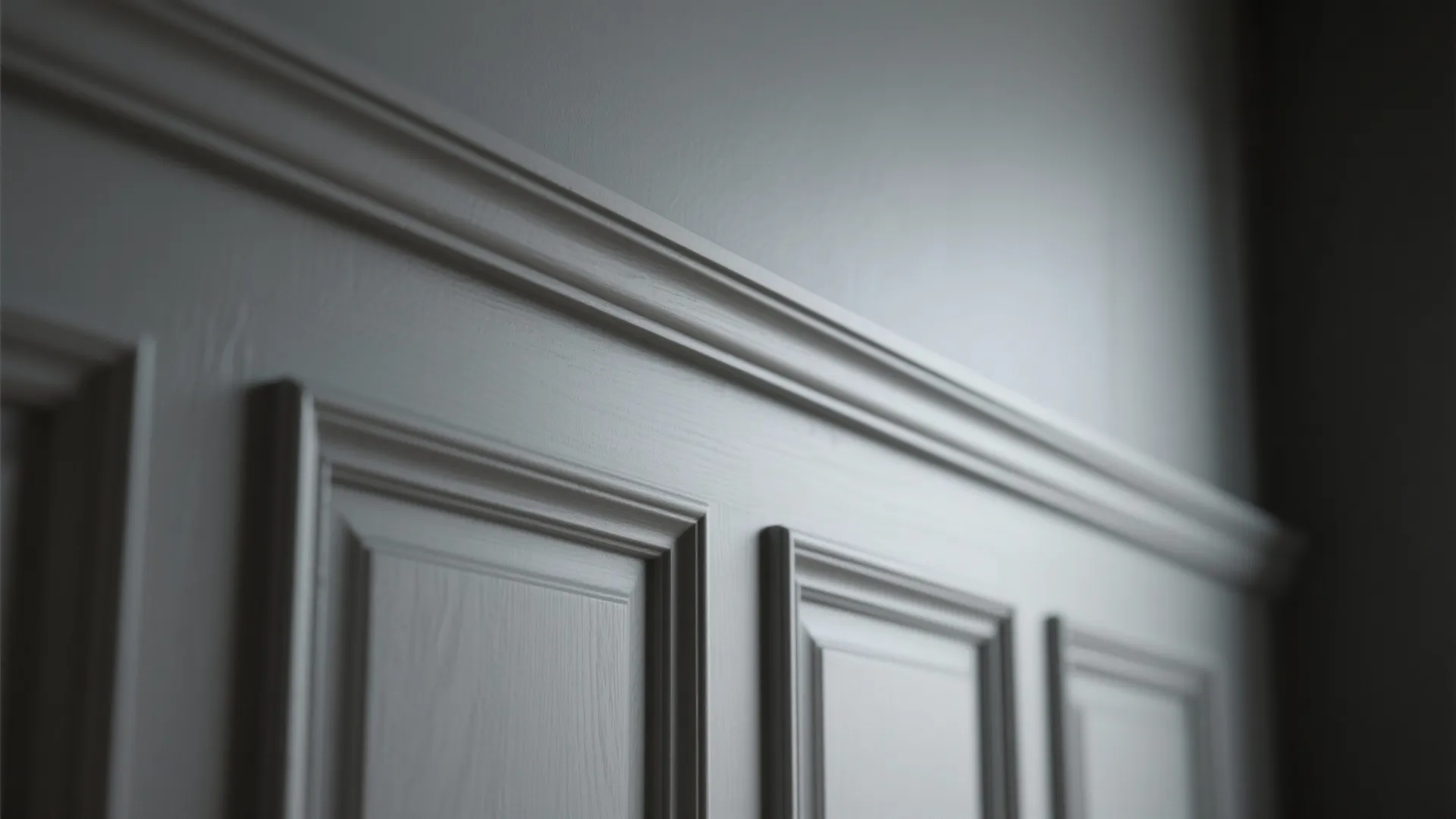 Close up of white wall panel design with decorative trim and soft lighting in room