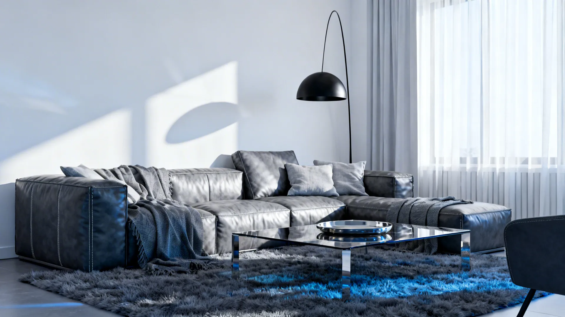 Monochrome living room with a grey leather couch, black lighting and layered grey textiles