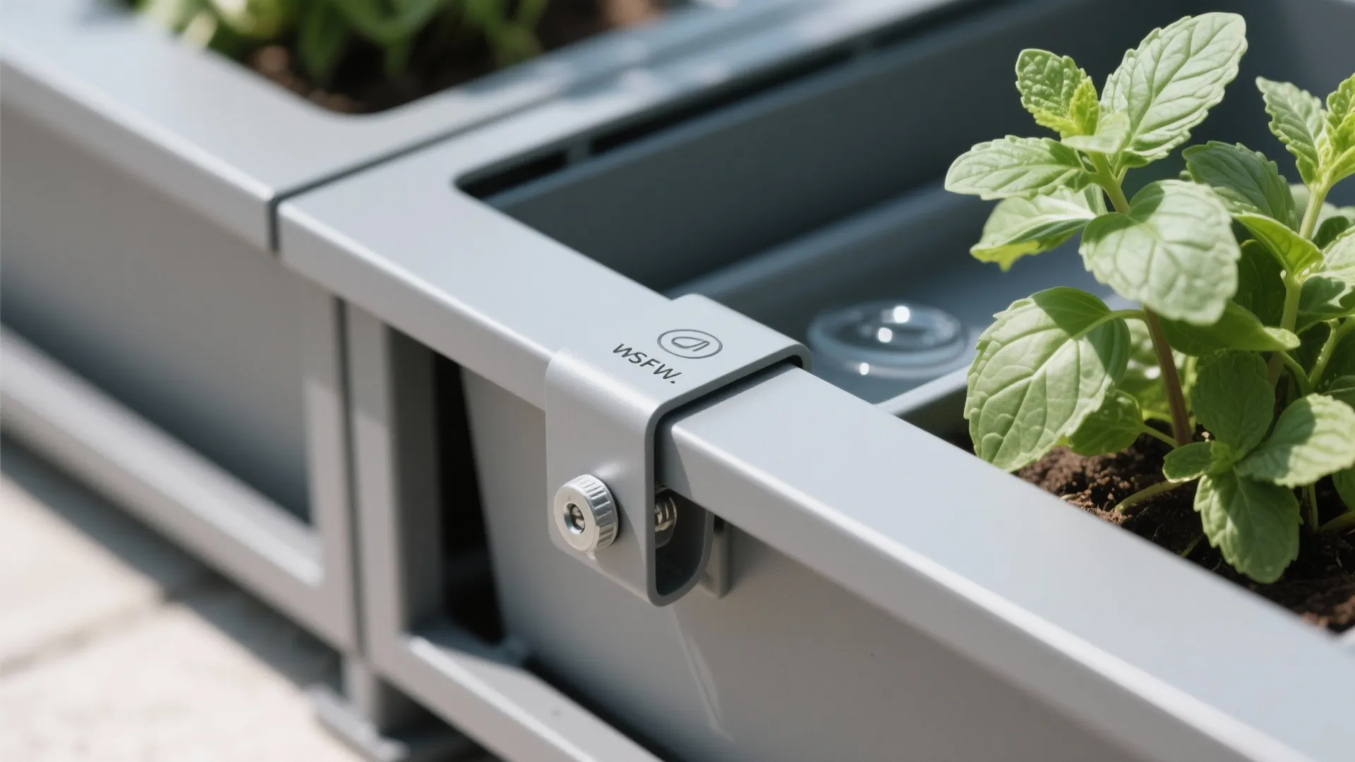 Close-up of clamp-on bracket and UV-stable planter on a powder-coated frame.