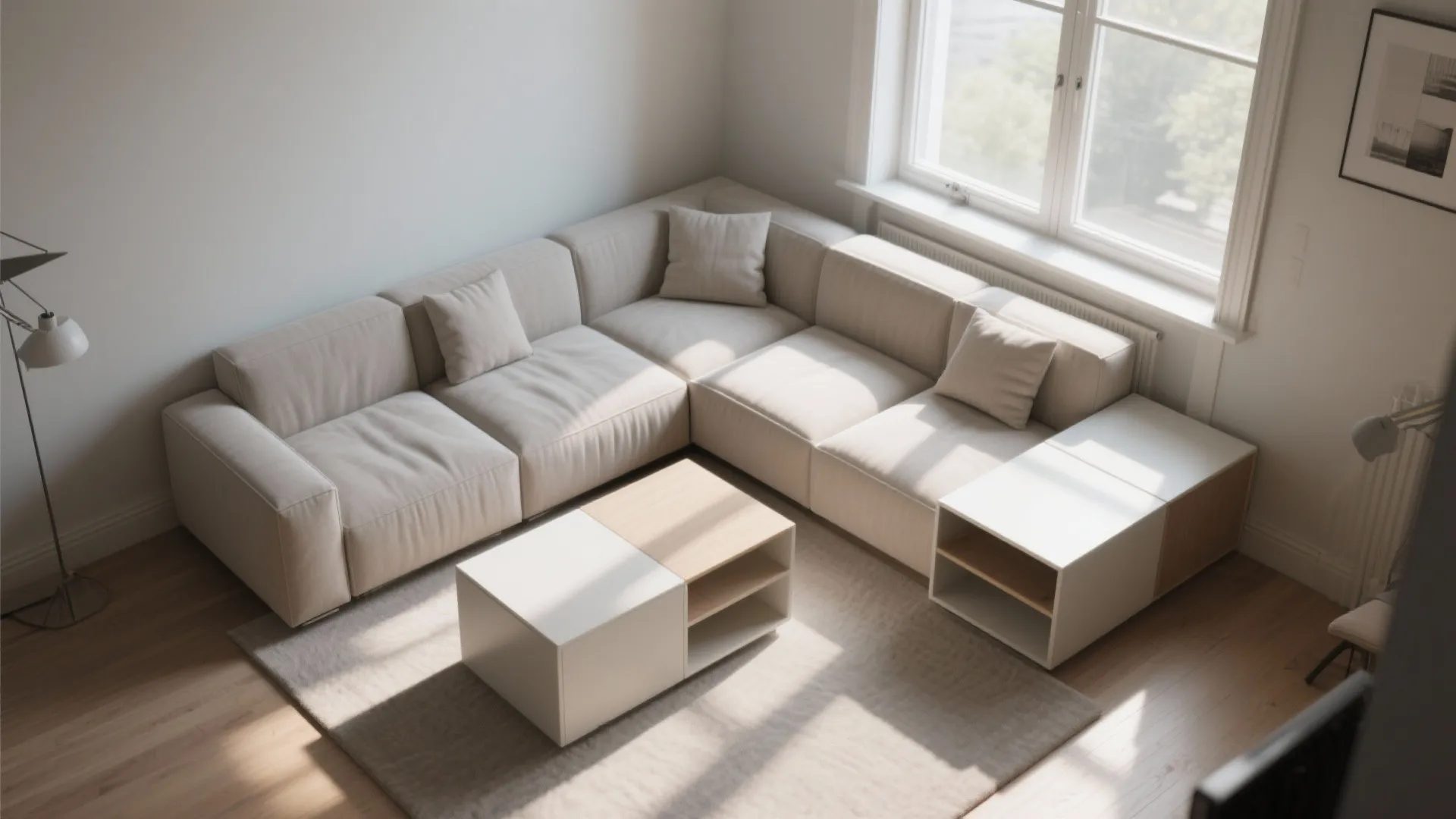 Modern cream modular sofa in sunlit living room with white coffee table and wooden floors