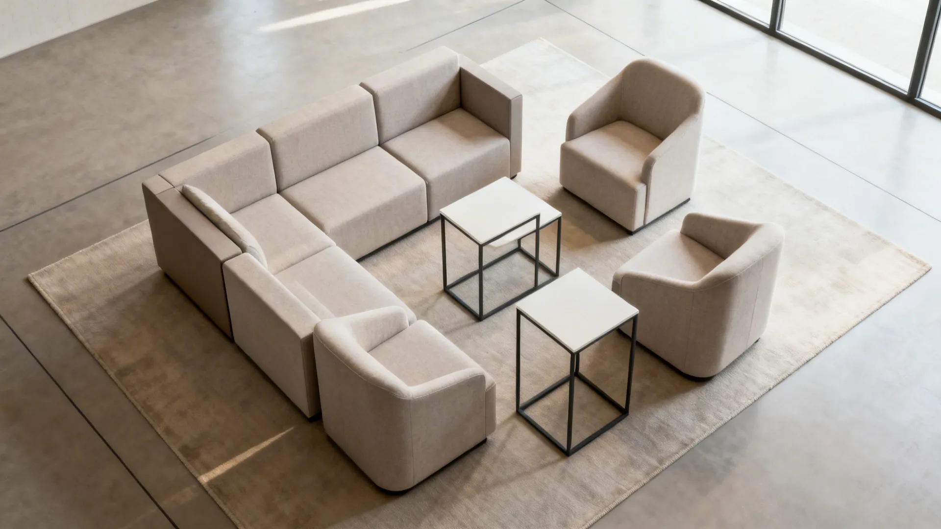 Top-down plan of a small living room with modular seating and nesting tables showing clear circulation.