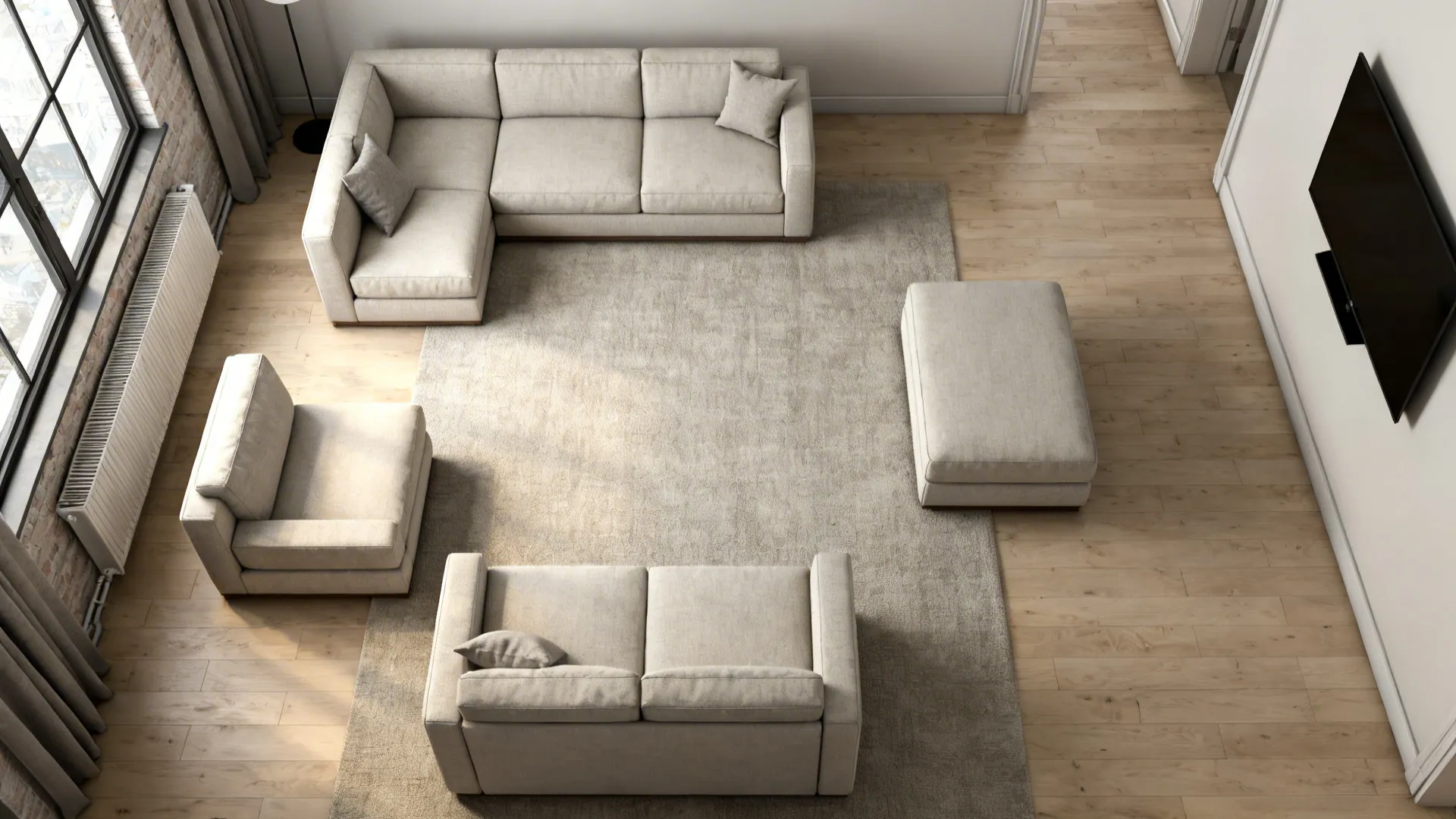 Top-down layout of a small loft showing a three-piece modular sectional and clear walking paths.