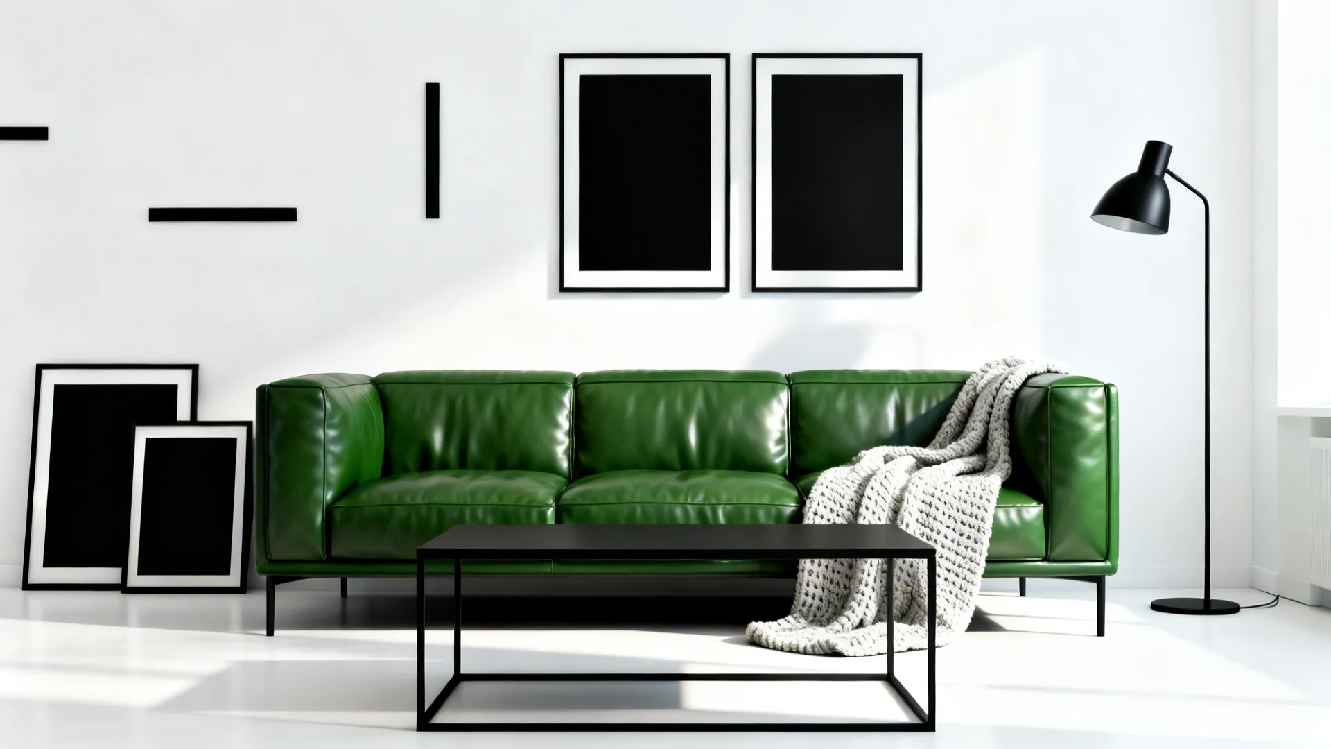 Modern green leather sofa with black coffee table and black picture frames on white wall