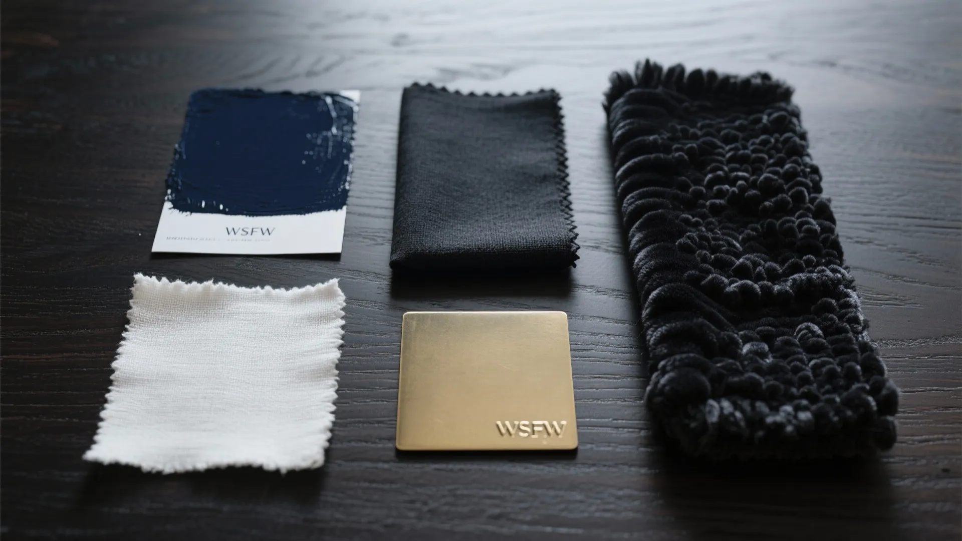 Interior design material board with blue paint white fabric black cloth and gold metal plate