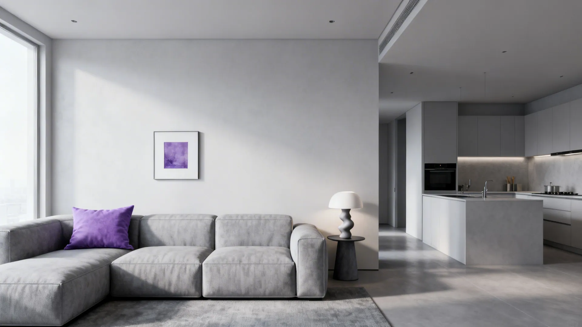 Modern grey sofa with a purple pillow in a minimalist room with a grey kitchen
