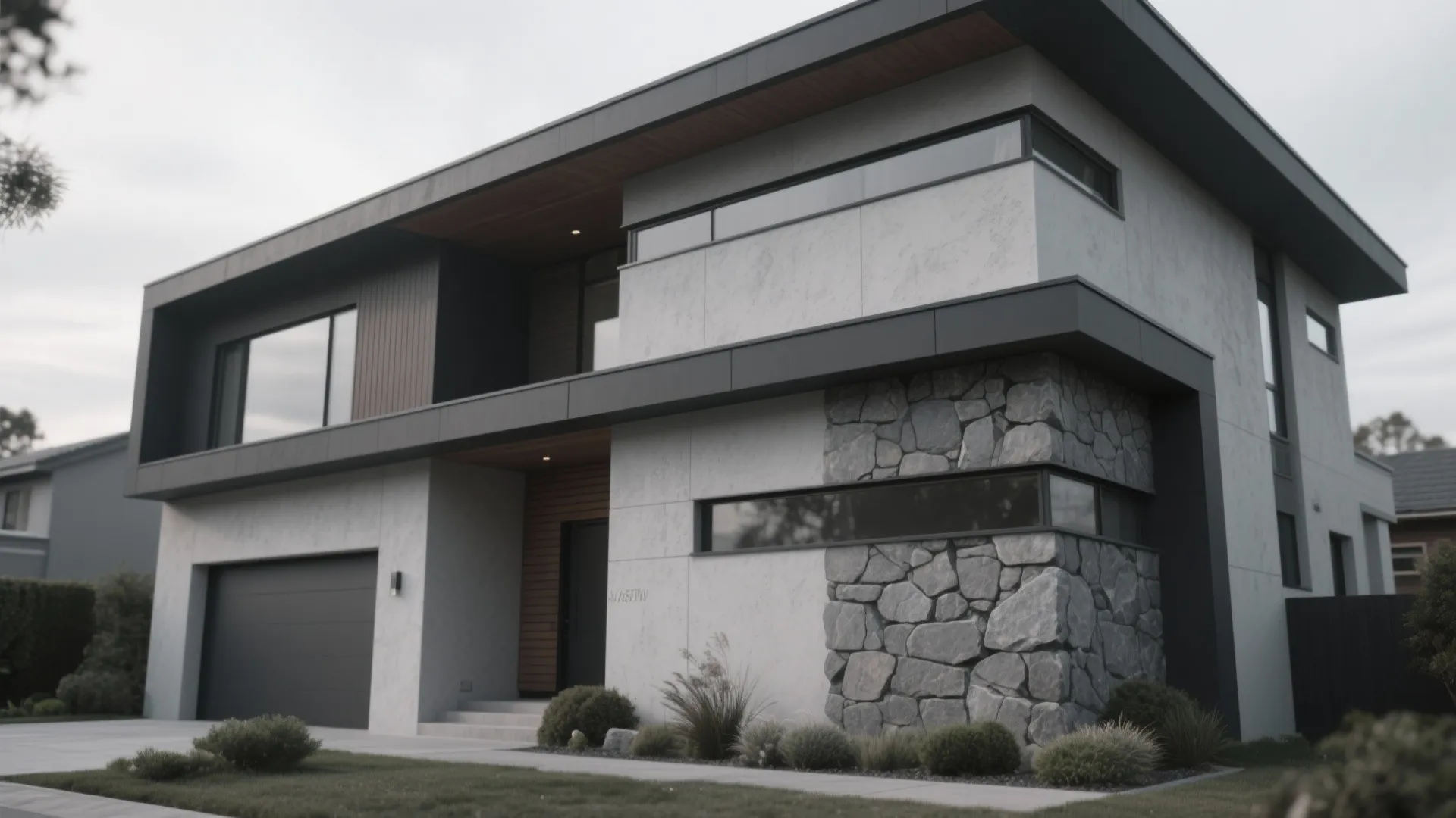 Modern two story house with white walls grey trim stone accents and large glass windows