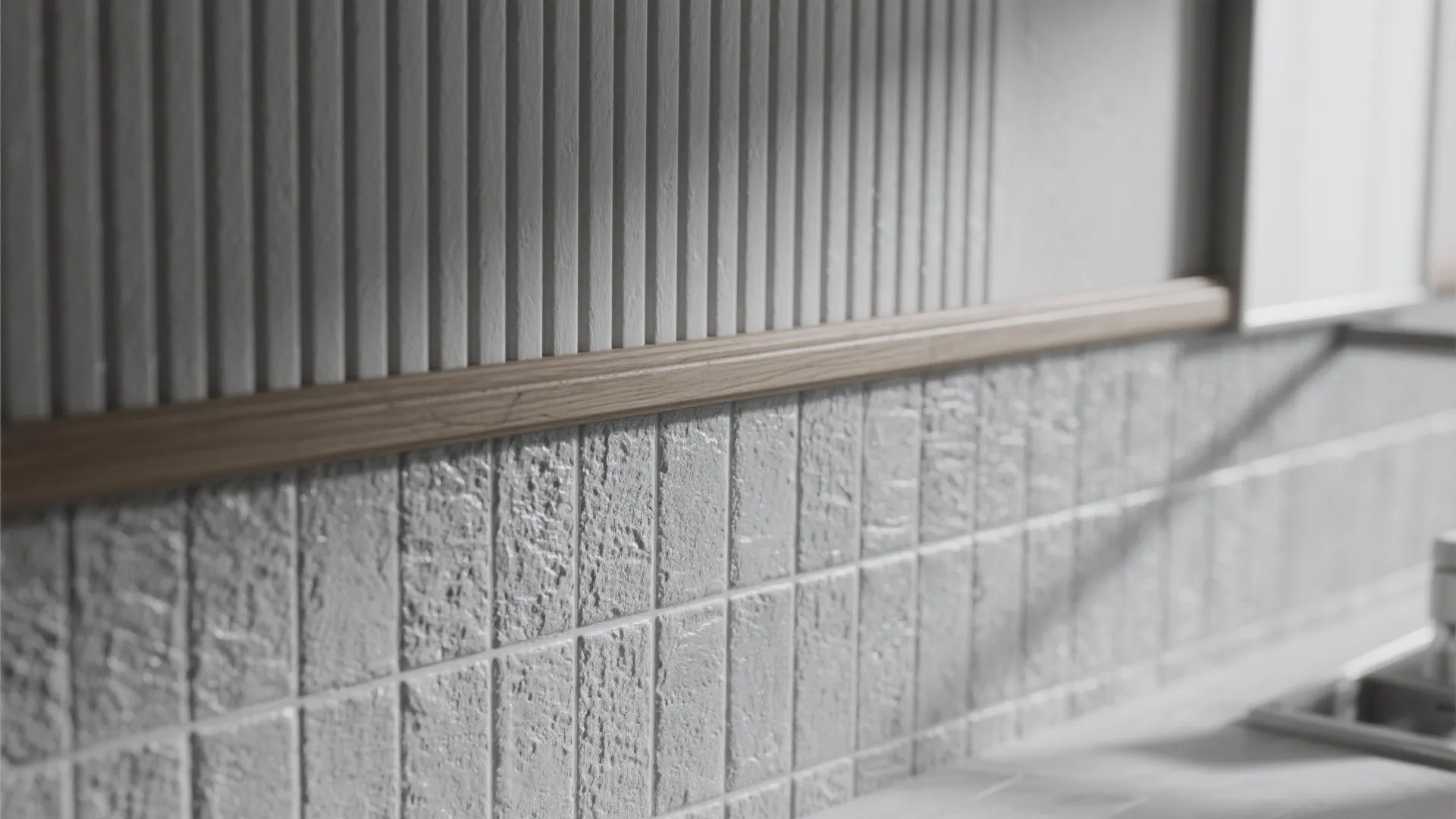 Close up of grey textured wall tiles and wood trim inside a modern kitchen design