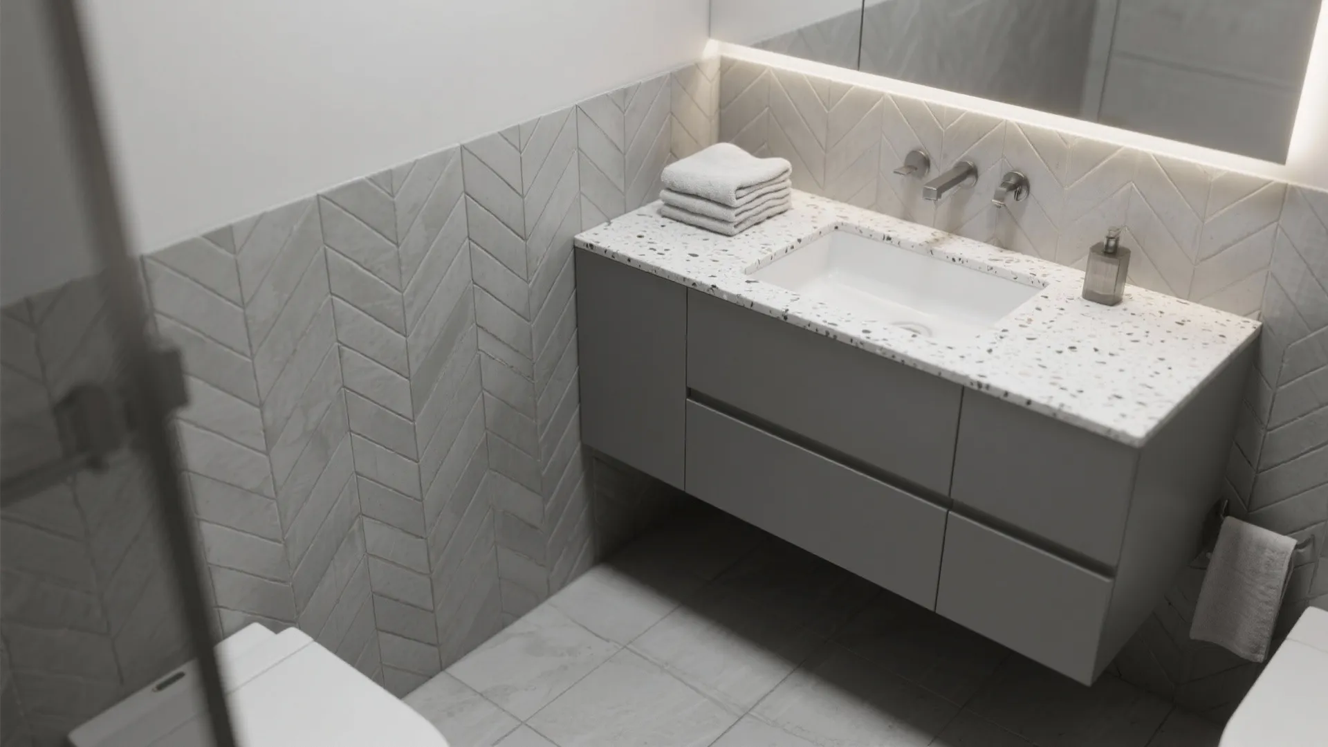 Modern bathroom with grey vanity cabinet stone countertop white sink and textured grey wall tiles