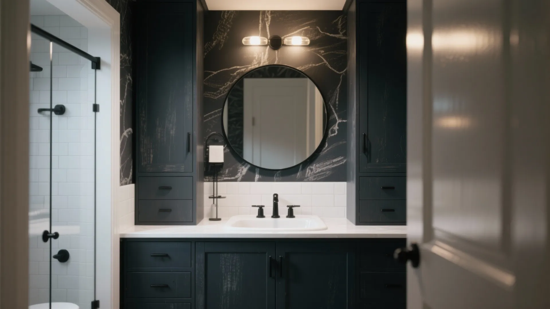 Small bathroom with a charcoal chalk-painted cabinet, white sink and matte black hardware for contrast.