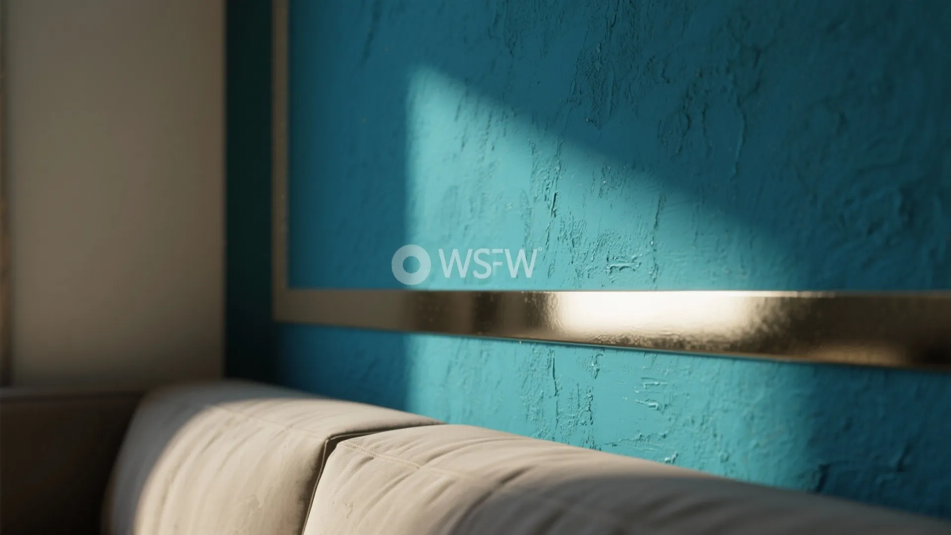 Deep teal accent wall with a slim high-gloss trim reflecting soft daylight and showing paint texture.