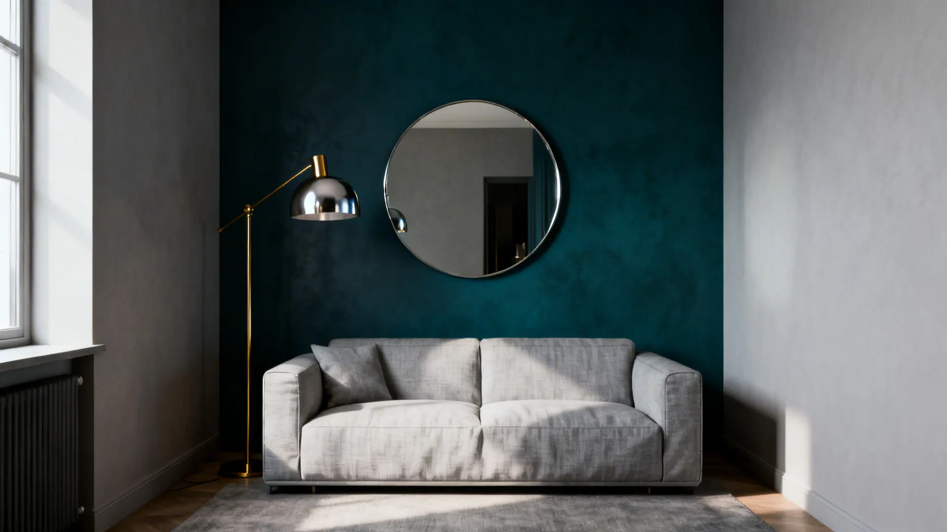 Living room with one deep teal accent wall, light gray sofa and brass lamp creating depth