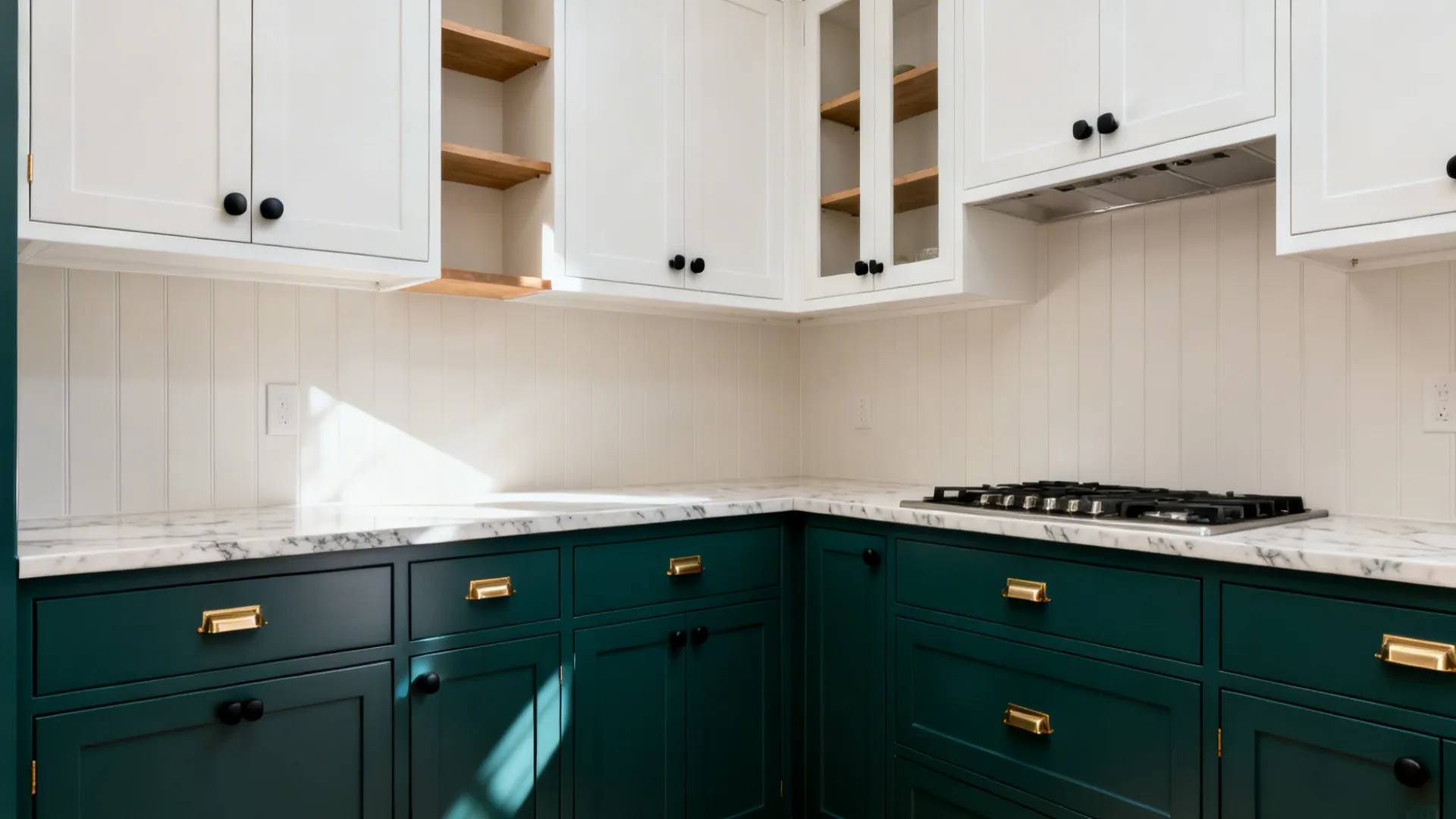 Deep teal lower cabinets with white uppers and a pale backsplash add depth in a small kitchen.