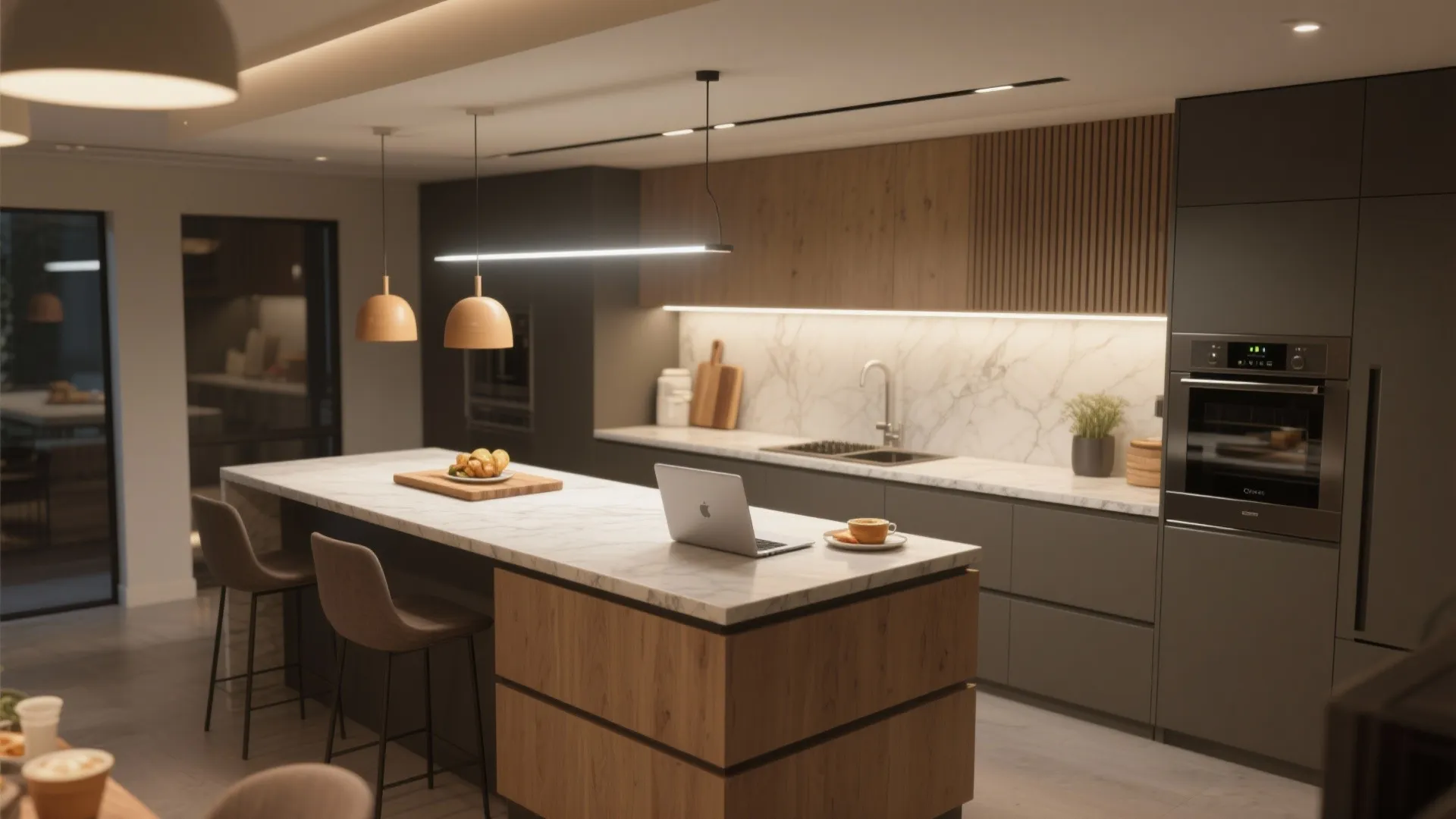 Multi-level kitchen island showing separate bar-height dining and lower prep/work surfaces with layered lighting.