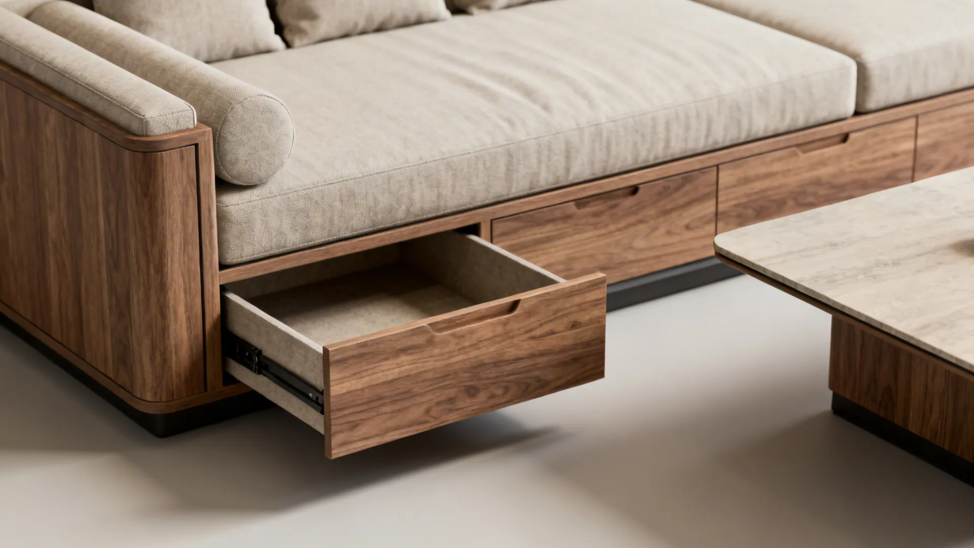 Close-up of a daybed with integrated storage drawers and a convertible table in a neutral palette.