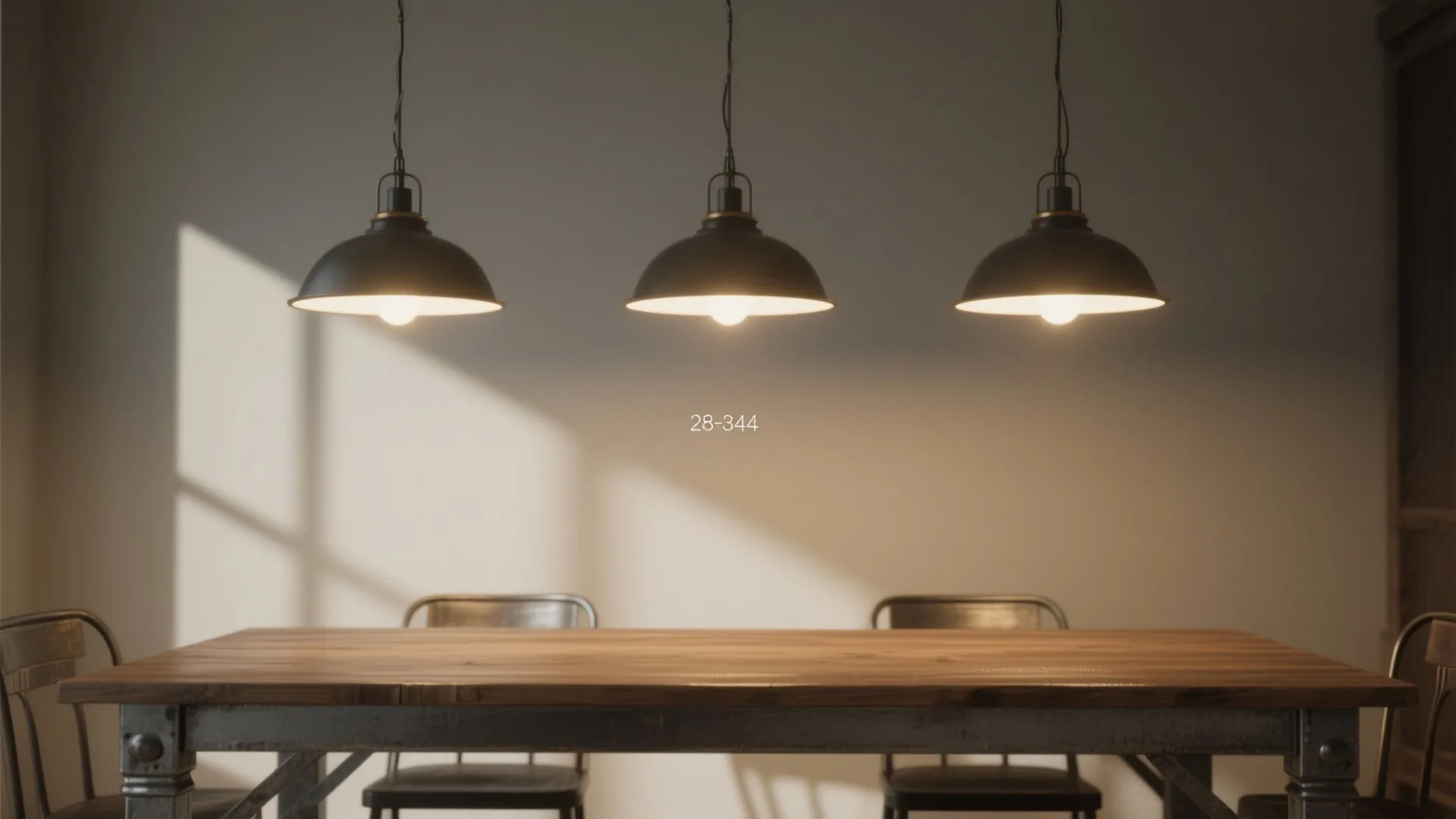 Long dining table illuminated by three evenly spaced pendants hung 28–34 inches above the table.