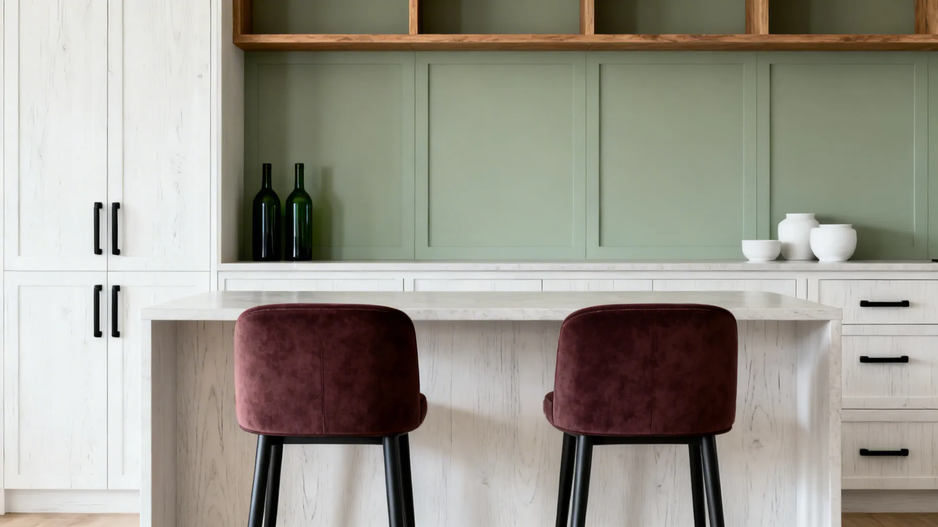 Merlot stools and sage shelf backboards with oak cabinetry under soft daylight.