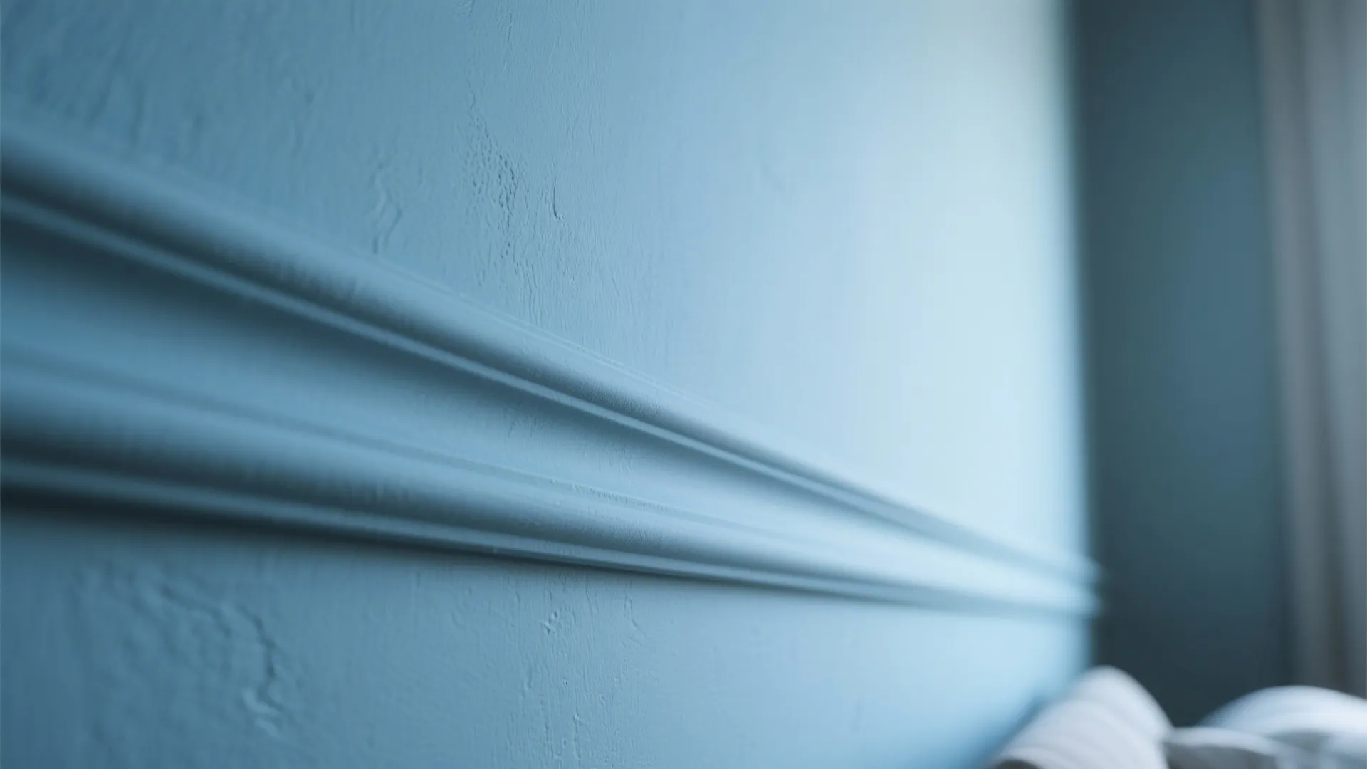Close up shot of light blue wall panel detail with matte finish and elegant molding