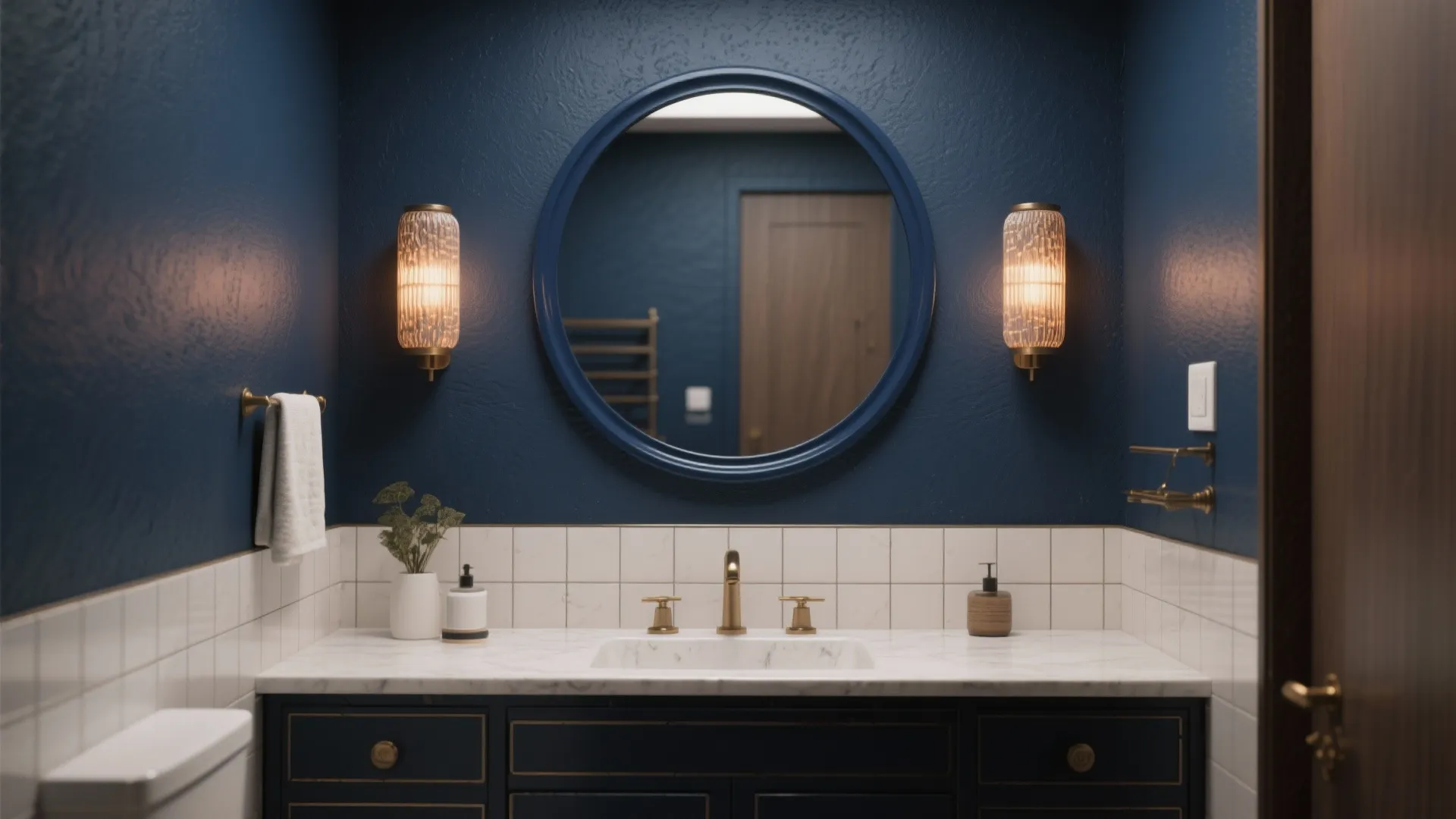 Small bathroom with a deep navy accent wall behind a vanity and circular mirror