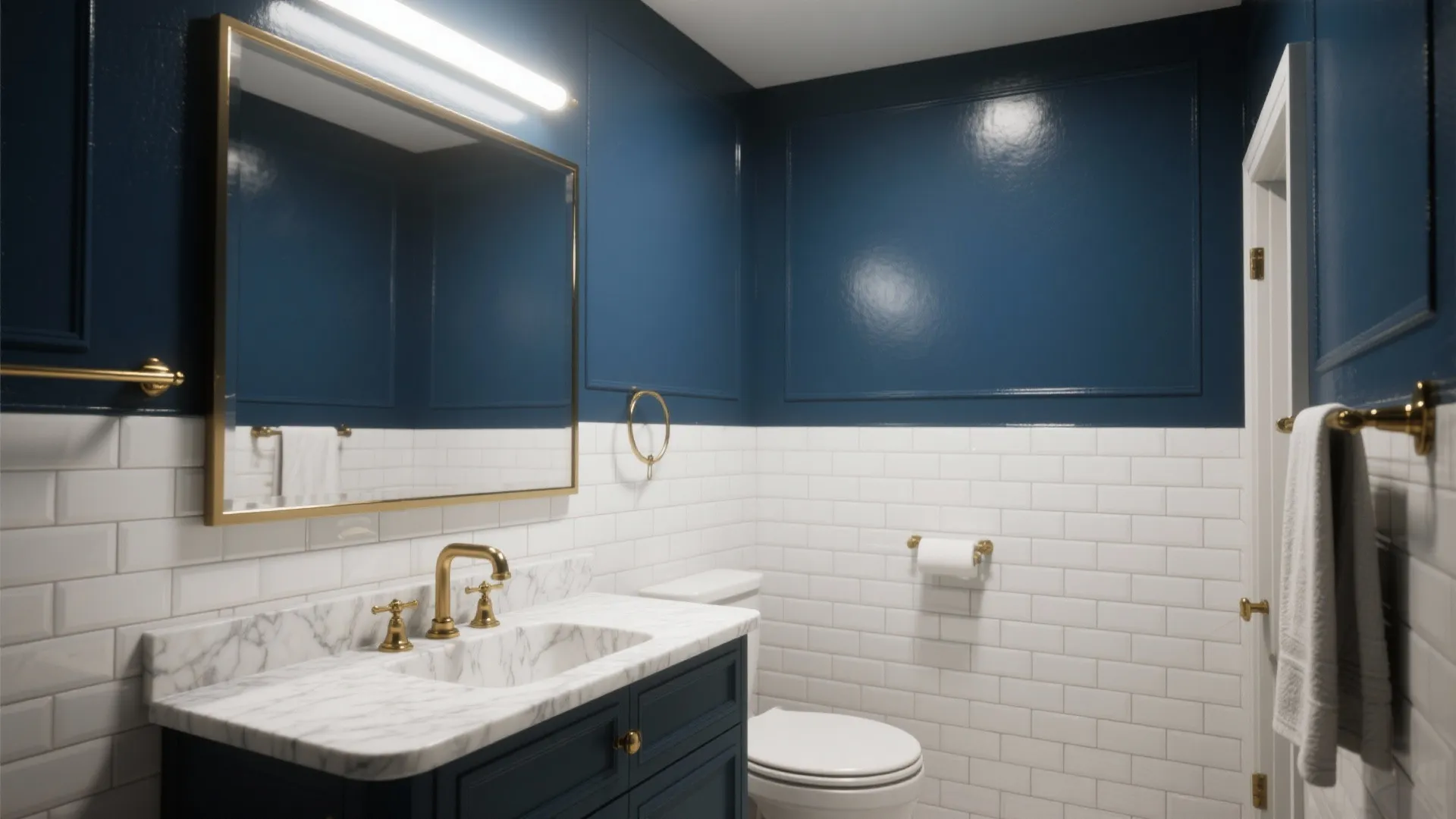 Modern navy blue bathroom featuring white brick tiles marble sink counter gold faucets and large mirror