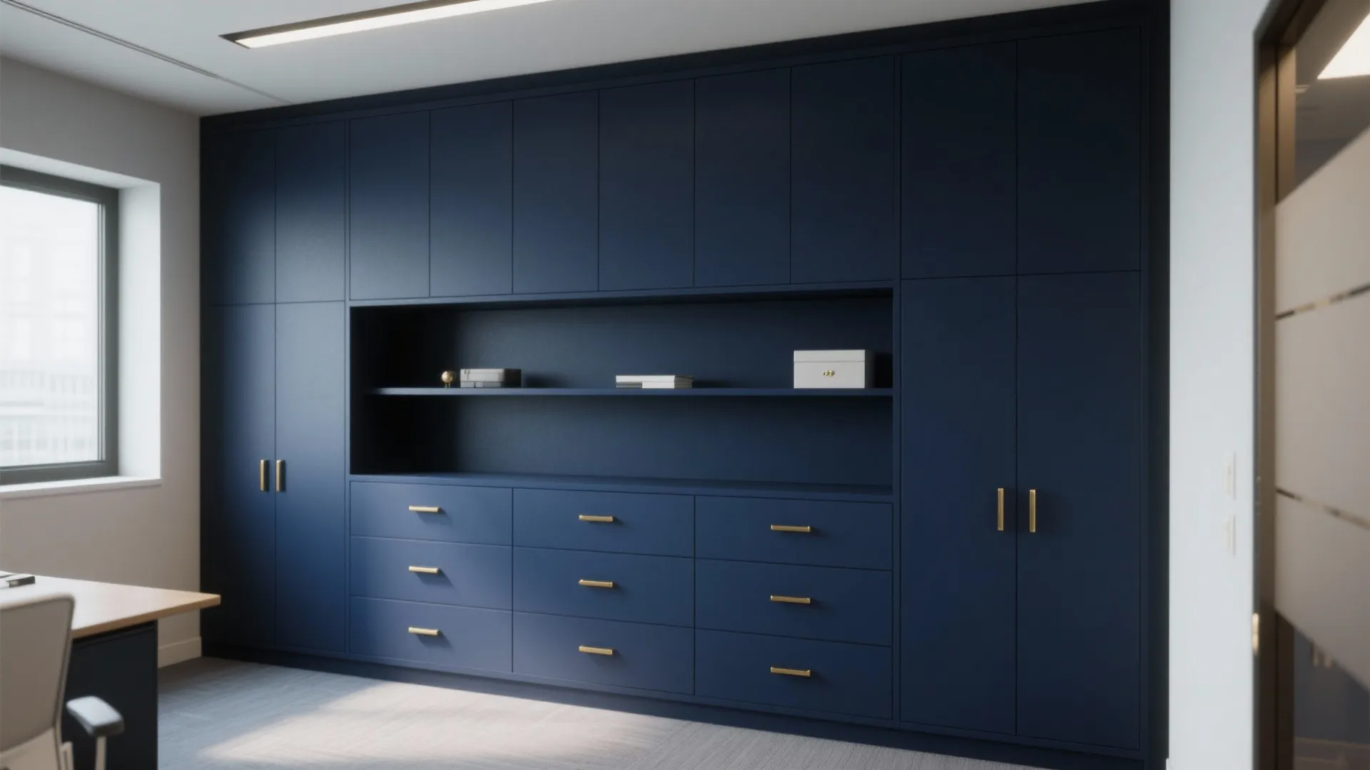 Large navy blue wall cabinet system with gold handles and shelves in a modern office