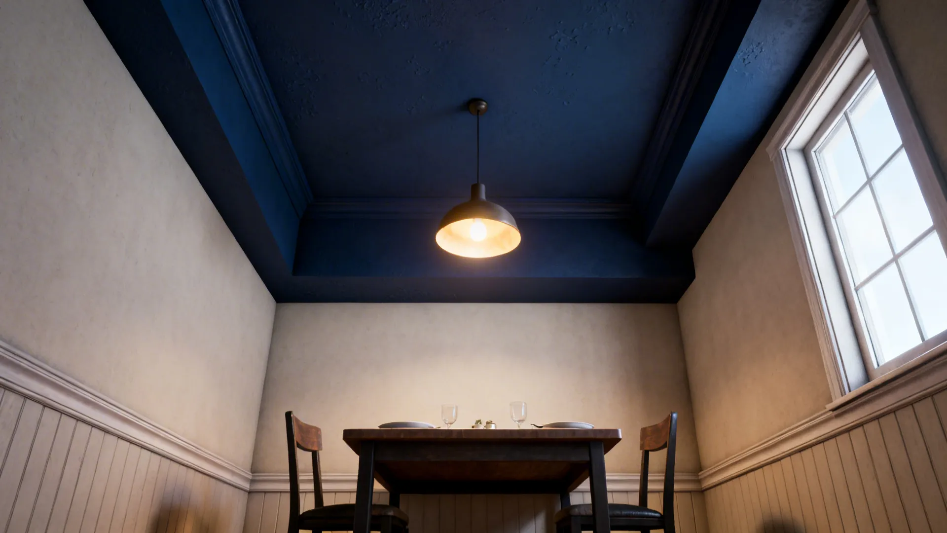 Dining nook with a navy ceiling and lighter walls creating a cozy feel