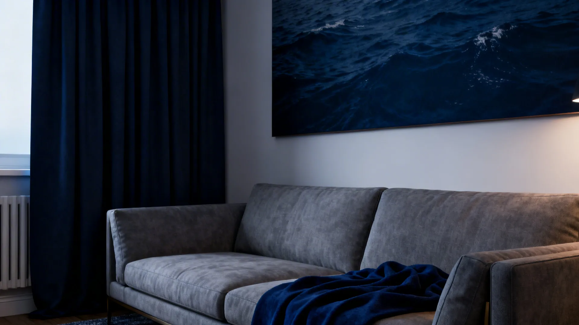 Grey sofa with deep navy curtains and artwork creating a sophisticated cozy feel