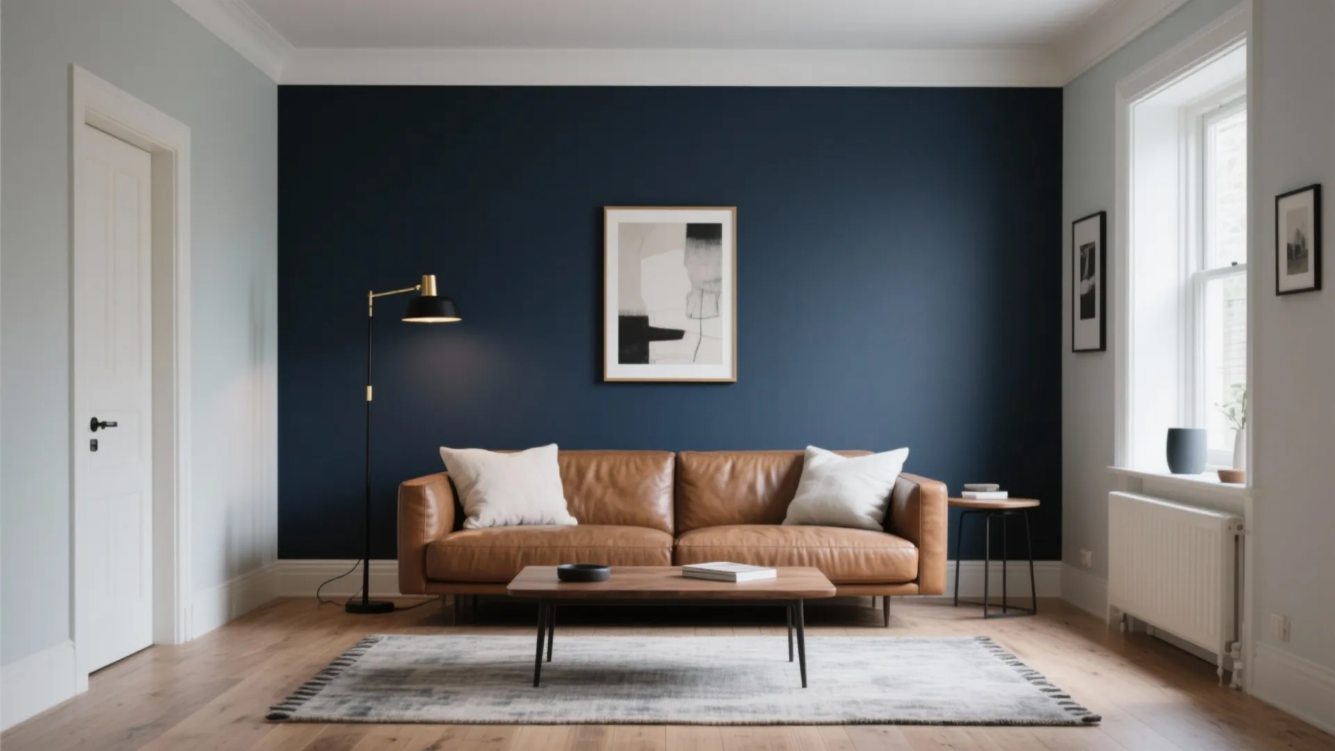 Living room featuring navy blue wall brown leather sofa white pillows floor lamp and wooden