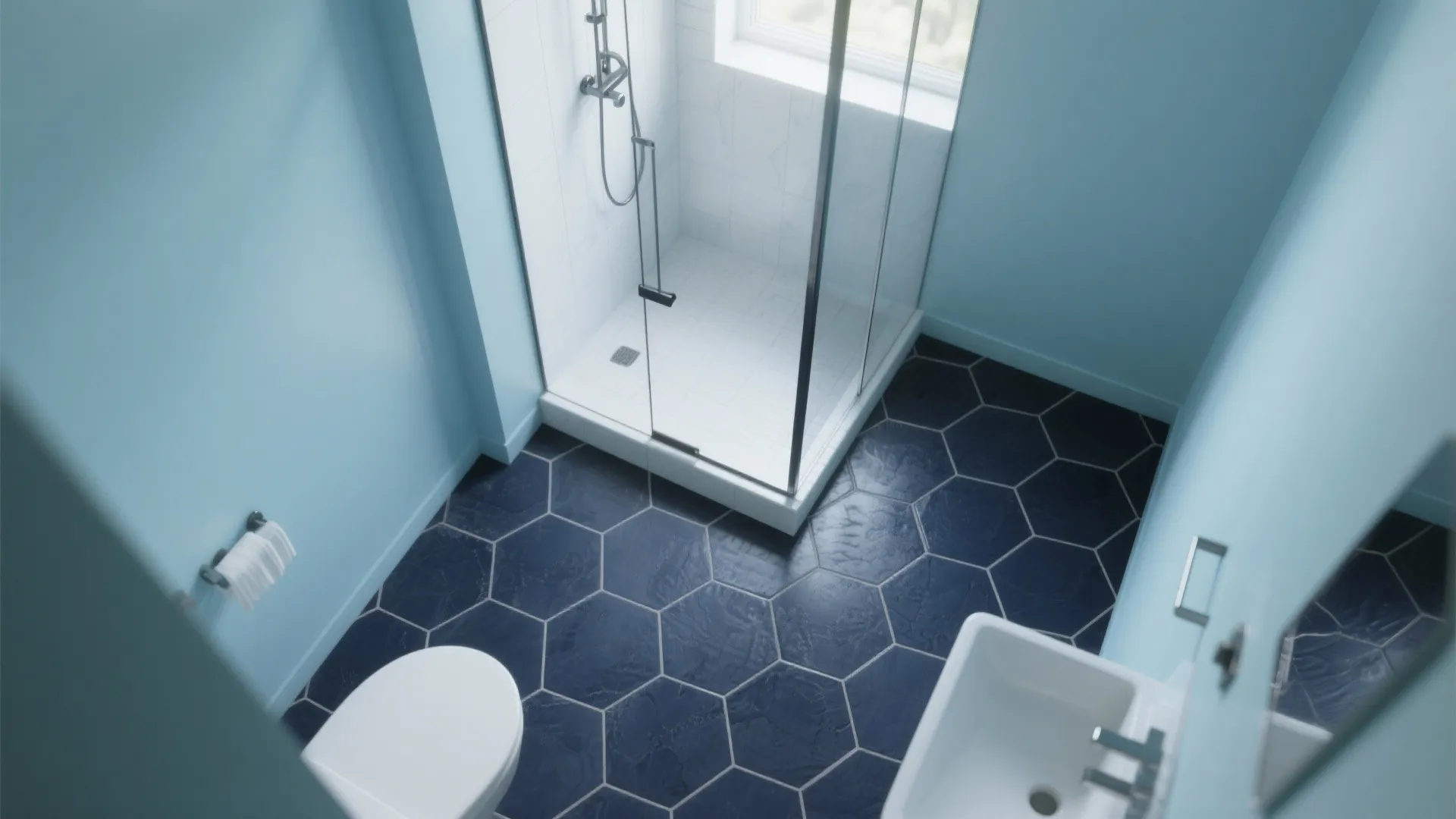 Matte navy hexagon floor tiles with mist-blue walls in a compact ensuite.