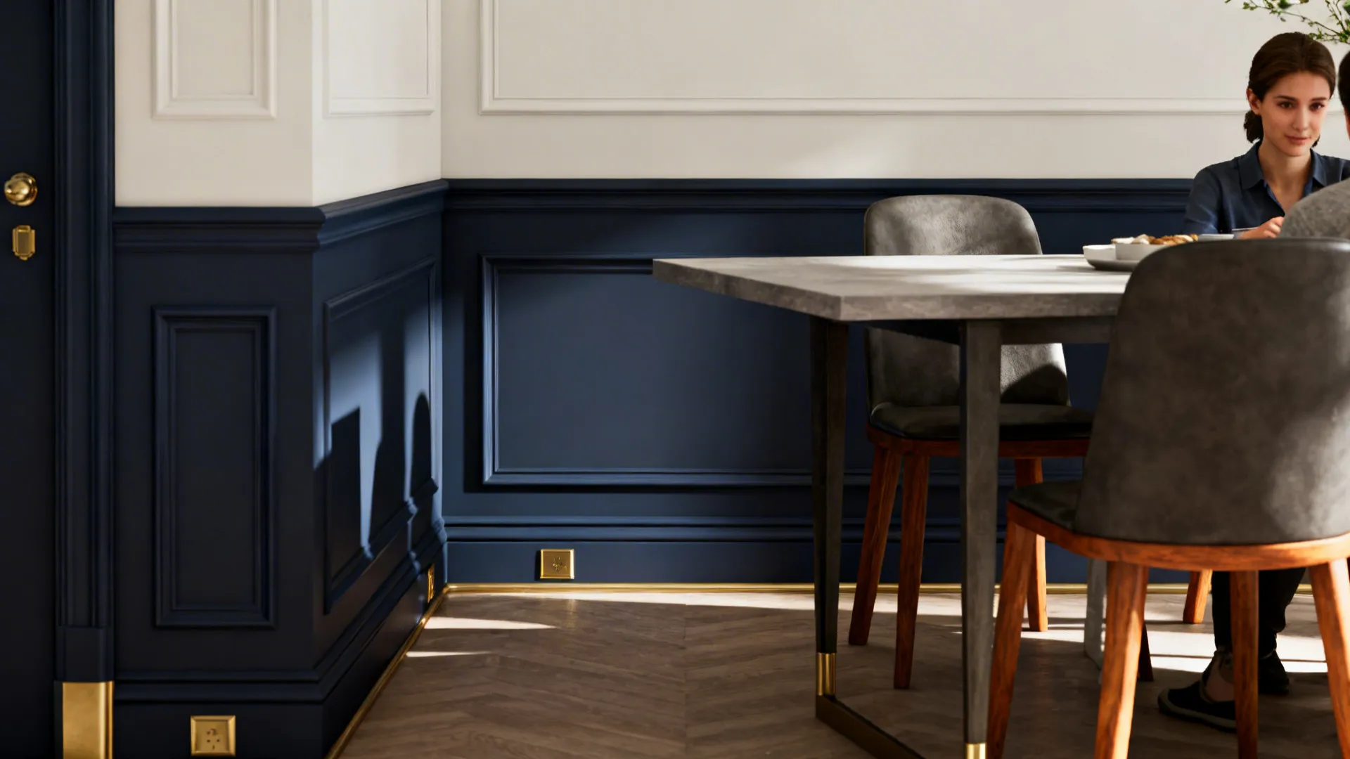 Dining area with deep navy lower walls and soft white upper walls, brass pendant and oak table