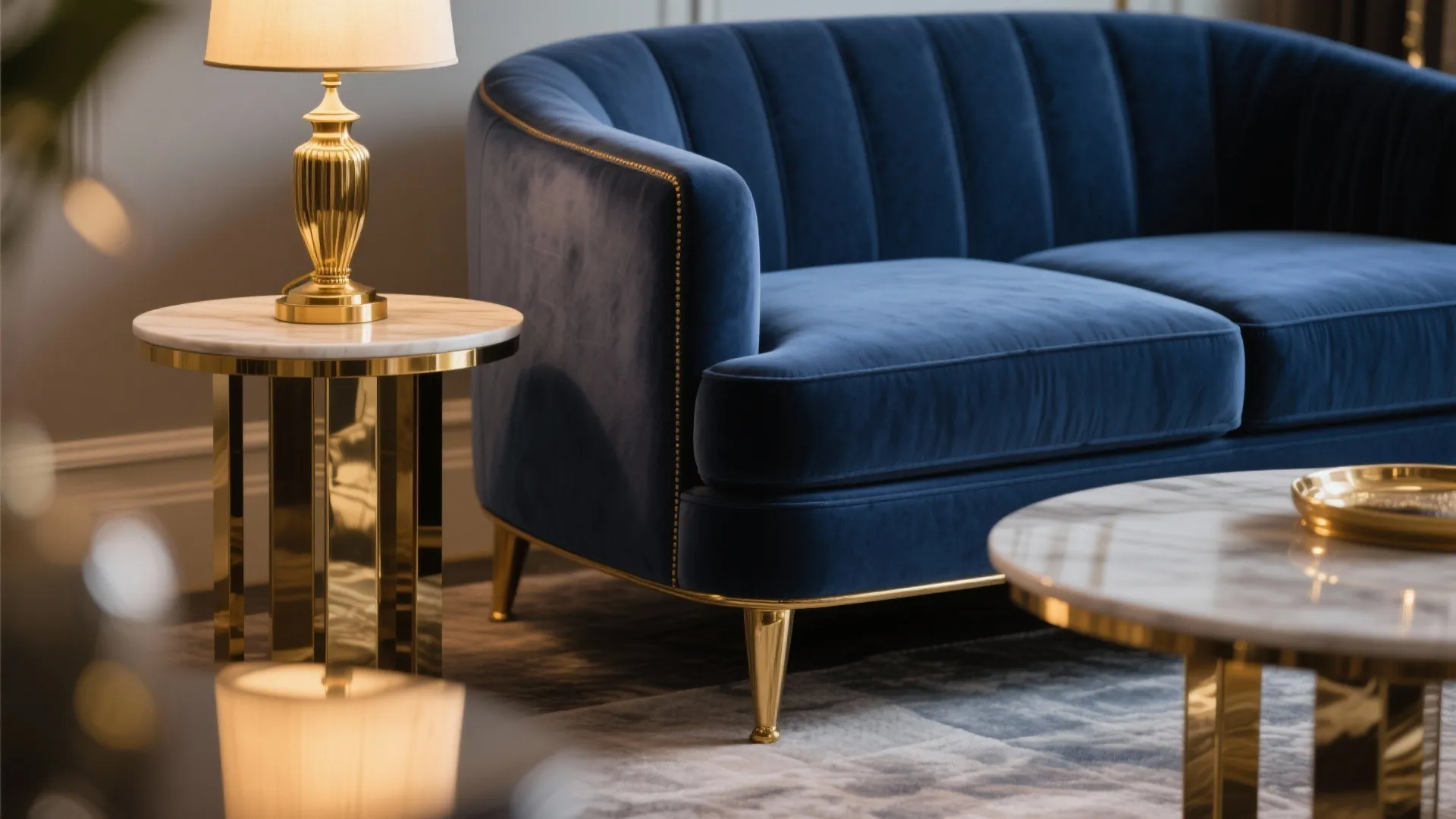 Luxury blue velvet sofa with gold metal legs marble side table and elegant gold table lamp