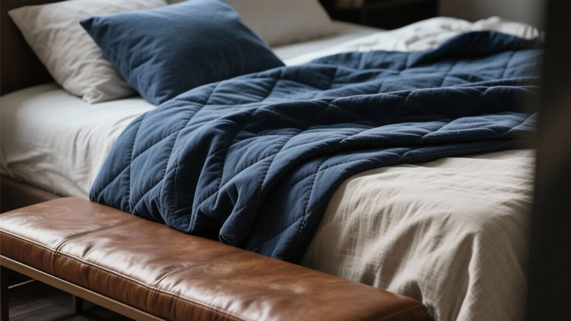 1. Layered textiles: navy quilt + warm brown leather