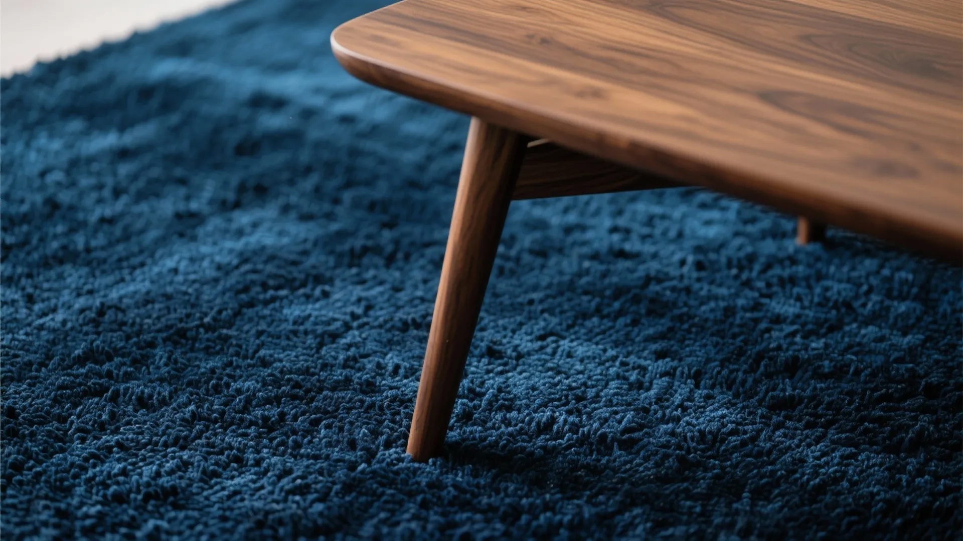 3. Textured Navy Rug under Mid-Century Walnut Table