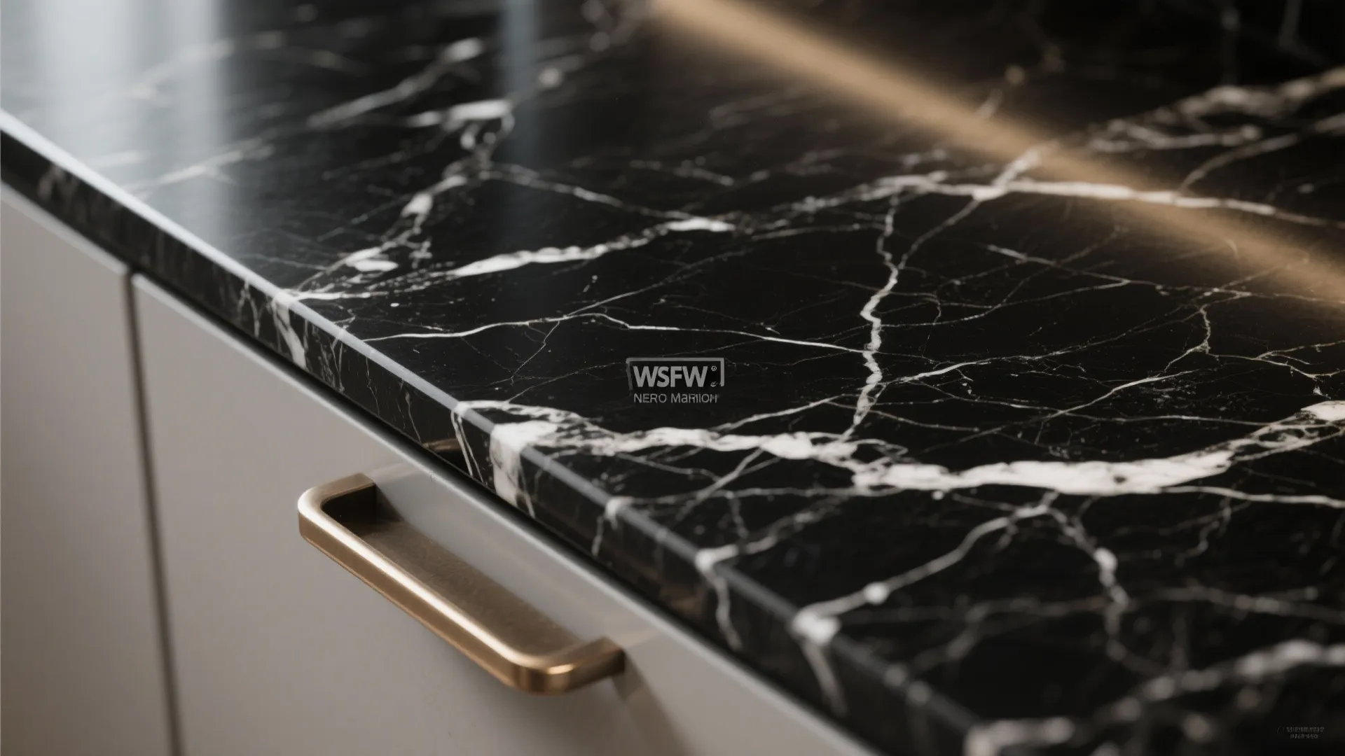 Macro view of black stone with soft white veining in a Nero Marquina style under soft daylight.