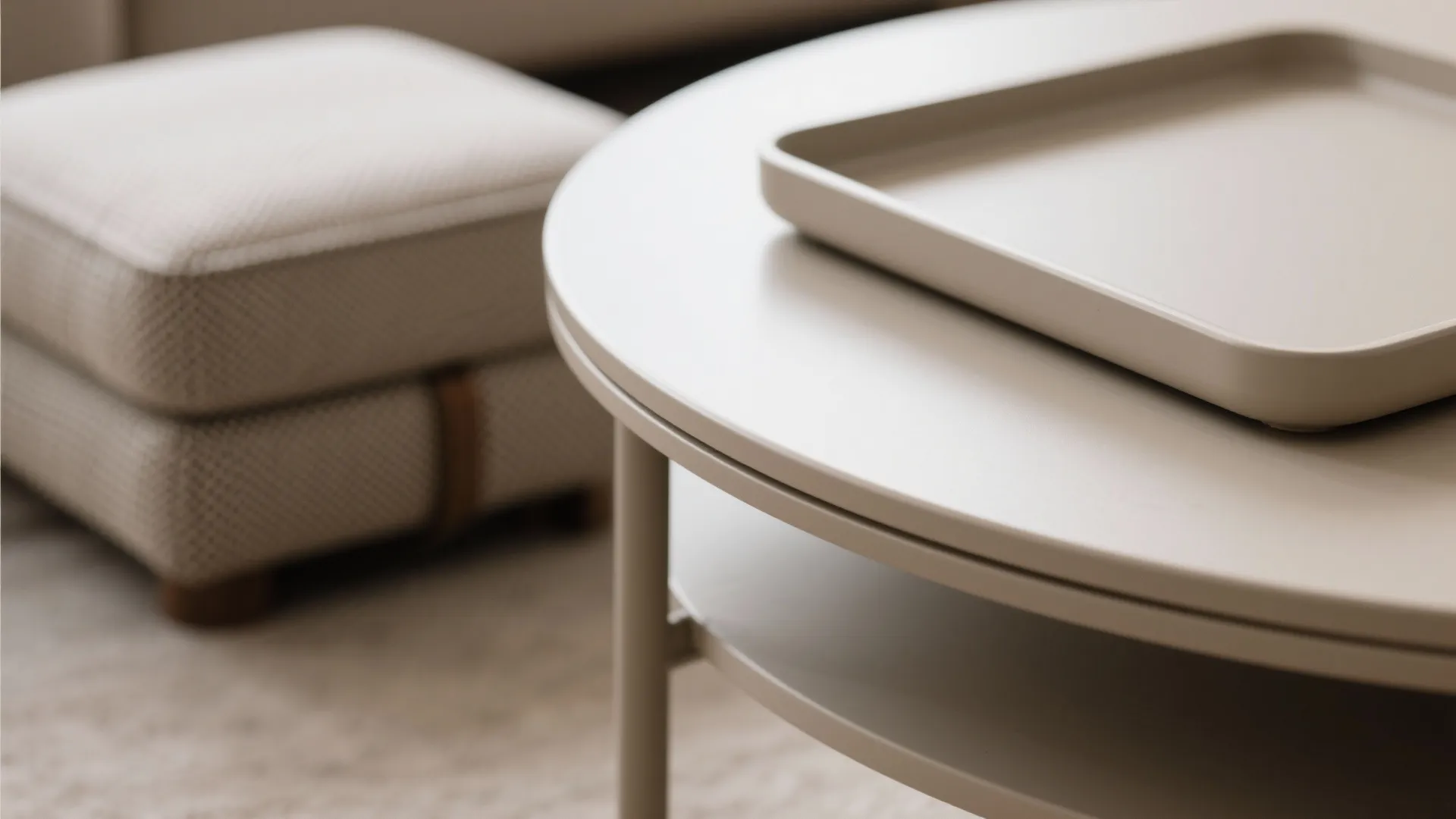 Macro of rounded table edge and ottoman fabric highlighting safe, durable finishes.