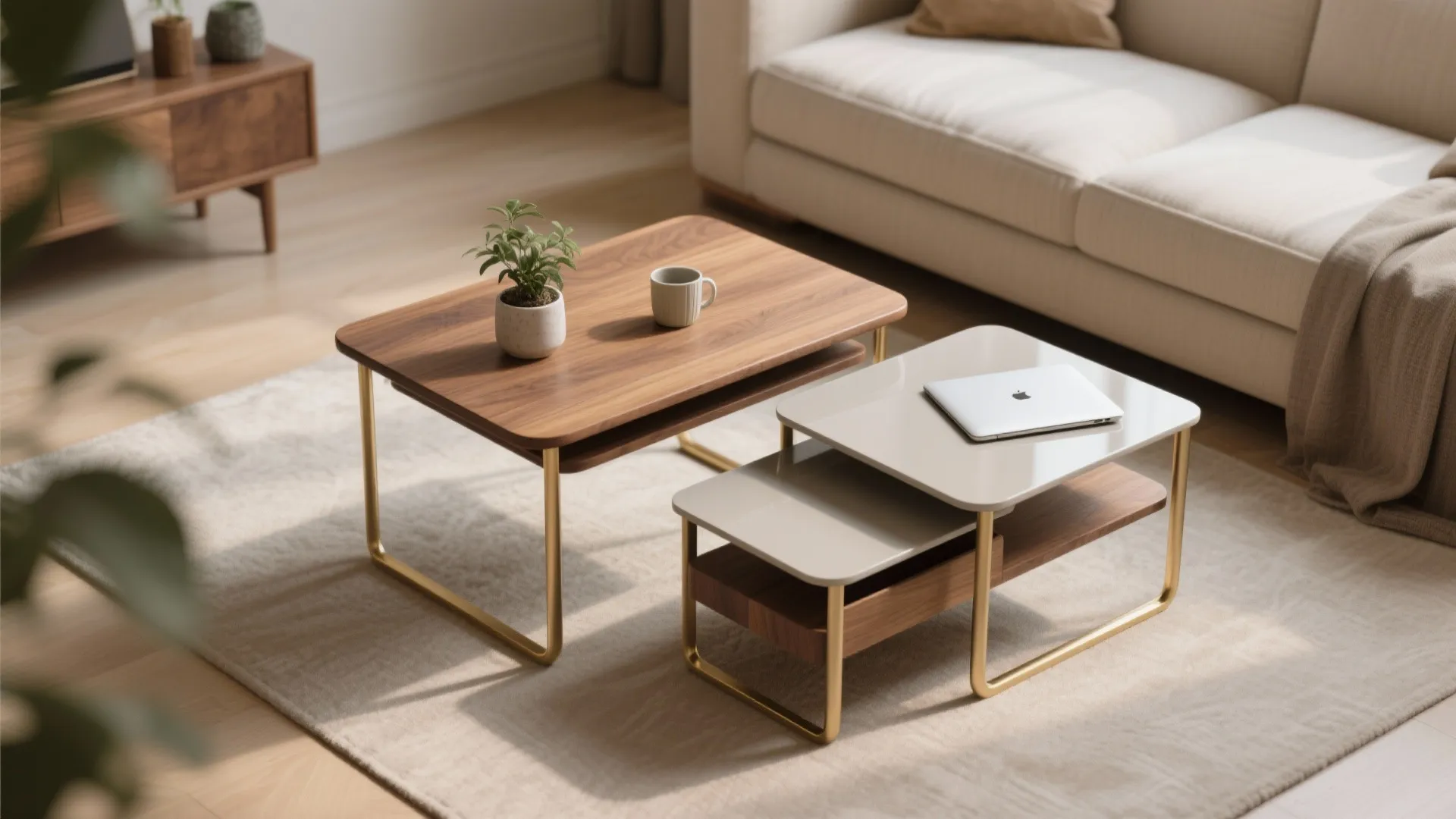 Two nesting coffee tables with gold legs on a rug near a beige fabric sofa