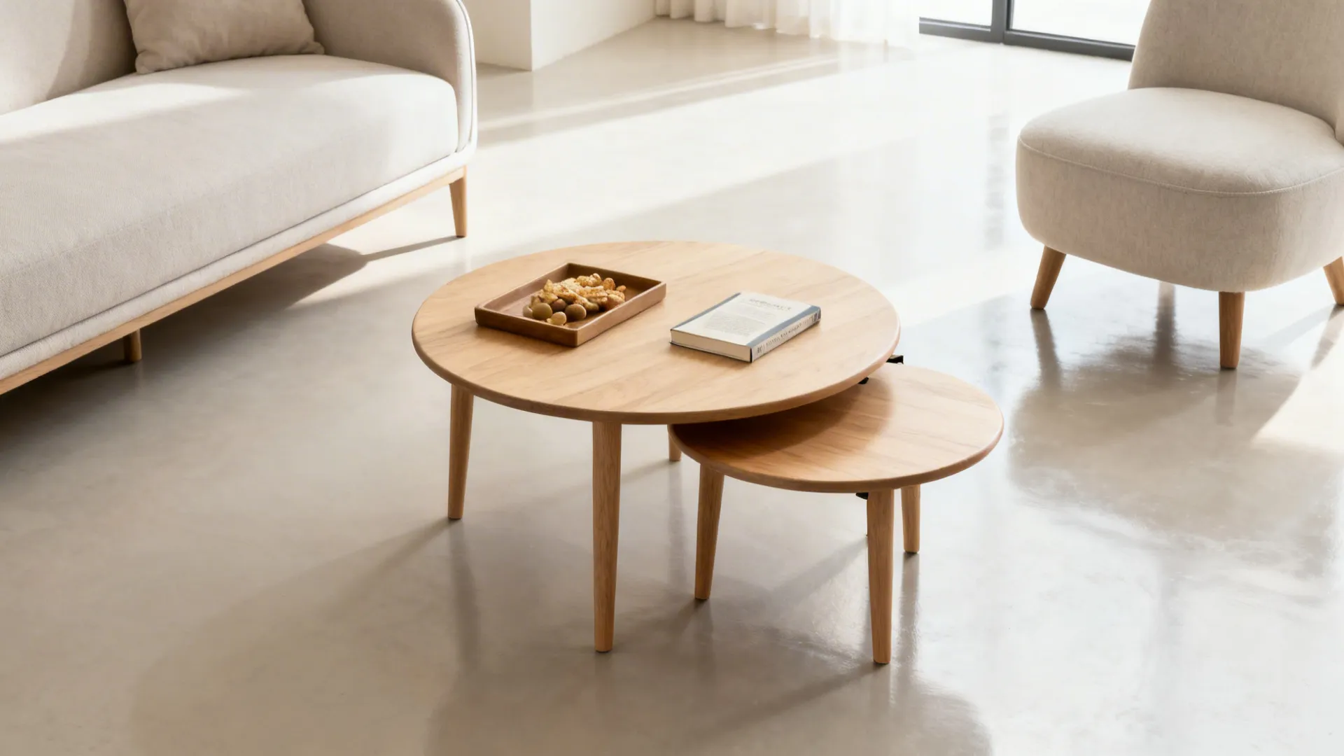 Round nesting coffee tables in light wood, partially pulled out in a small living room.