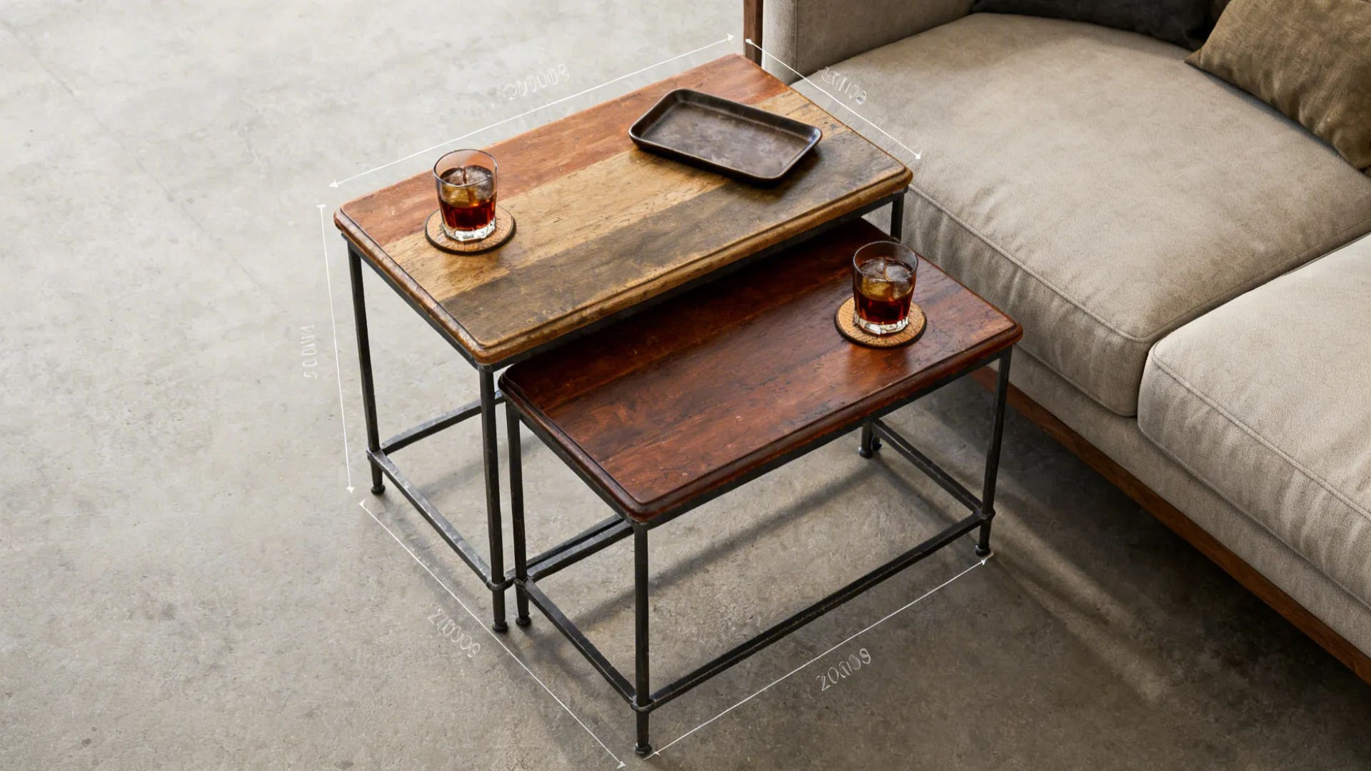 Two wooden nesting tables with metal legs placed next to sofa with glasses and tray