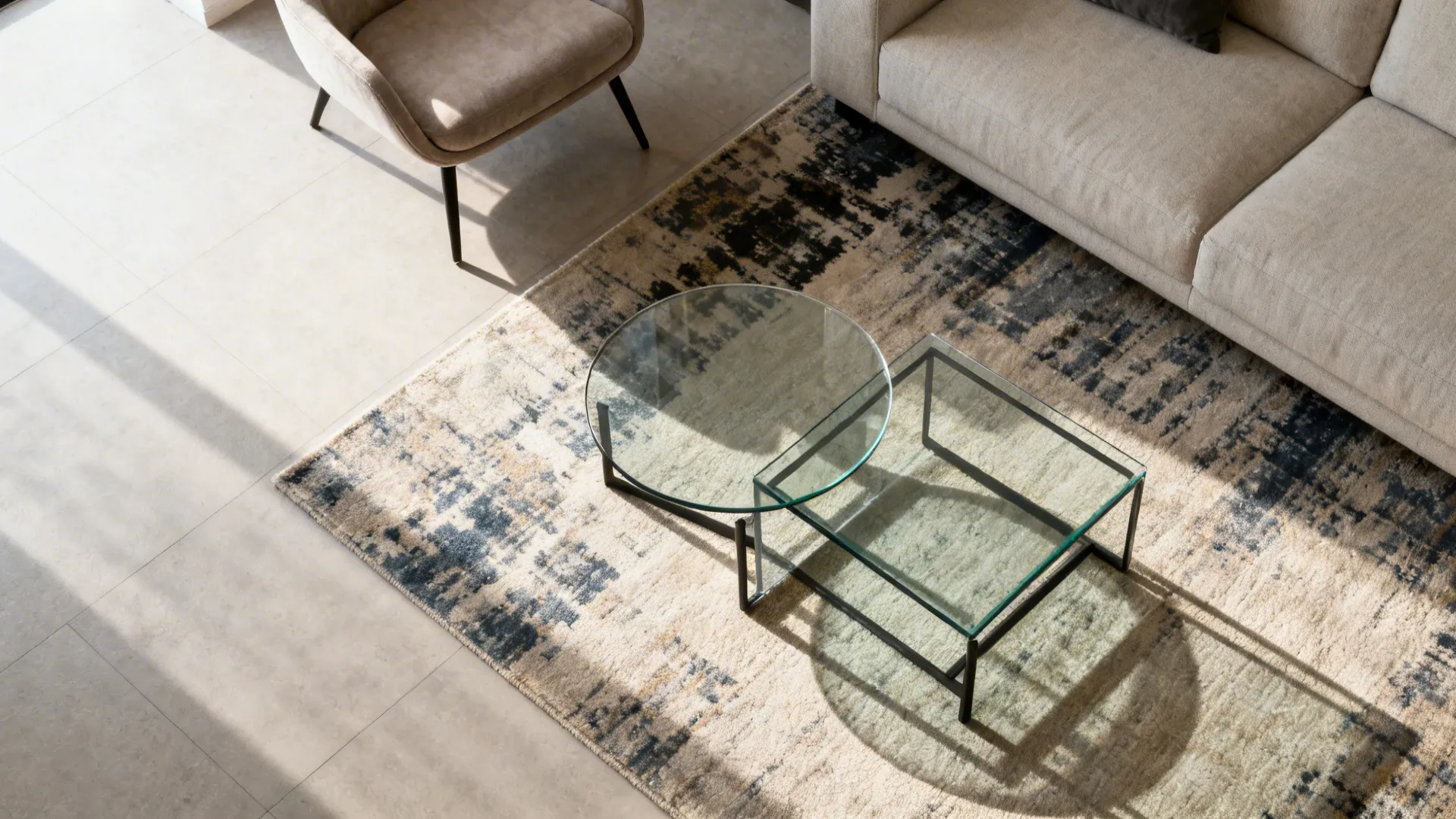 Top-down view of nesting glass tables near a sofa with clear walking paths.