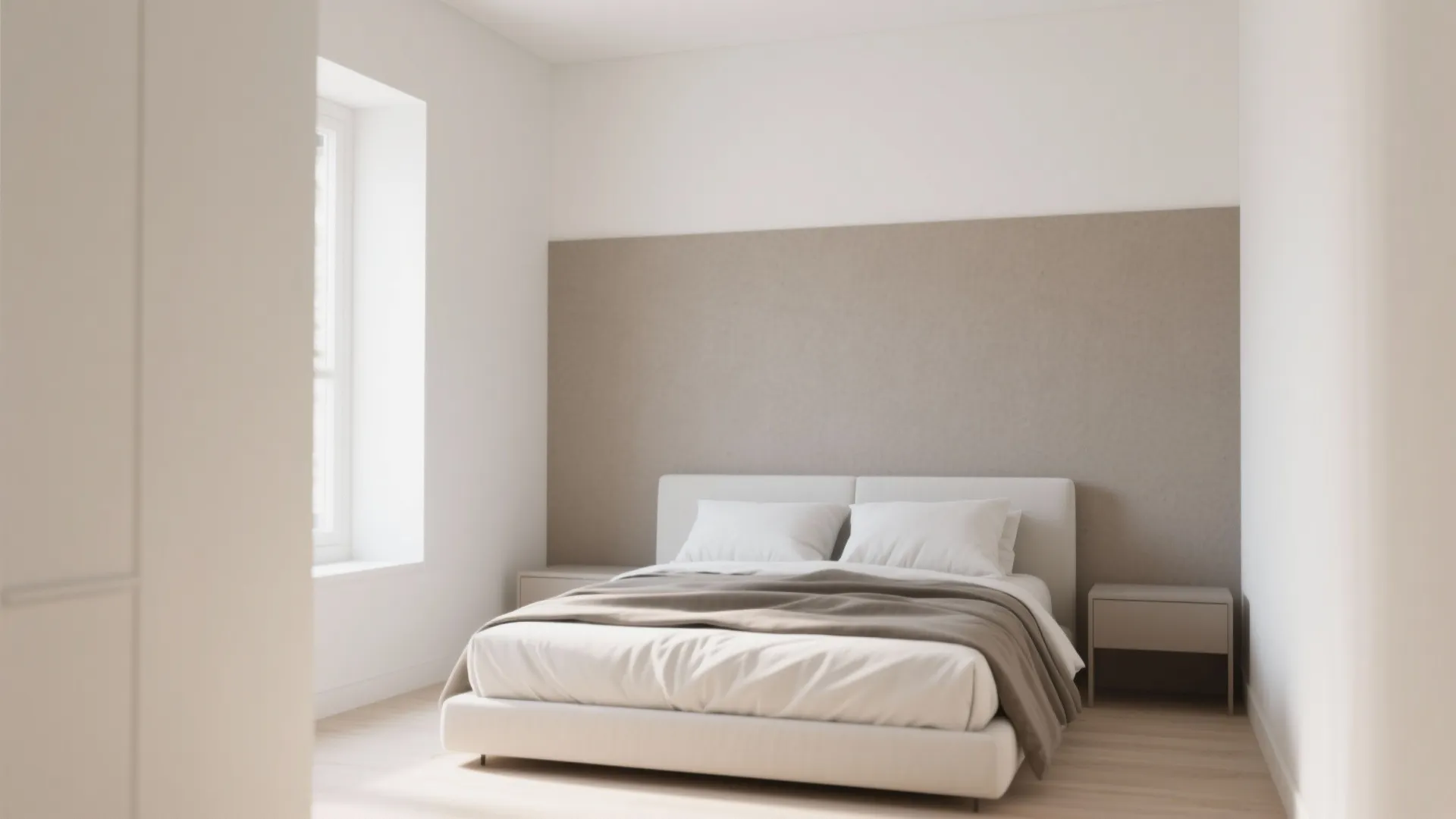 Small bedroom with light neutral walls and a single muted gray accent wall behind the bed.
