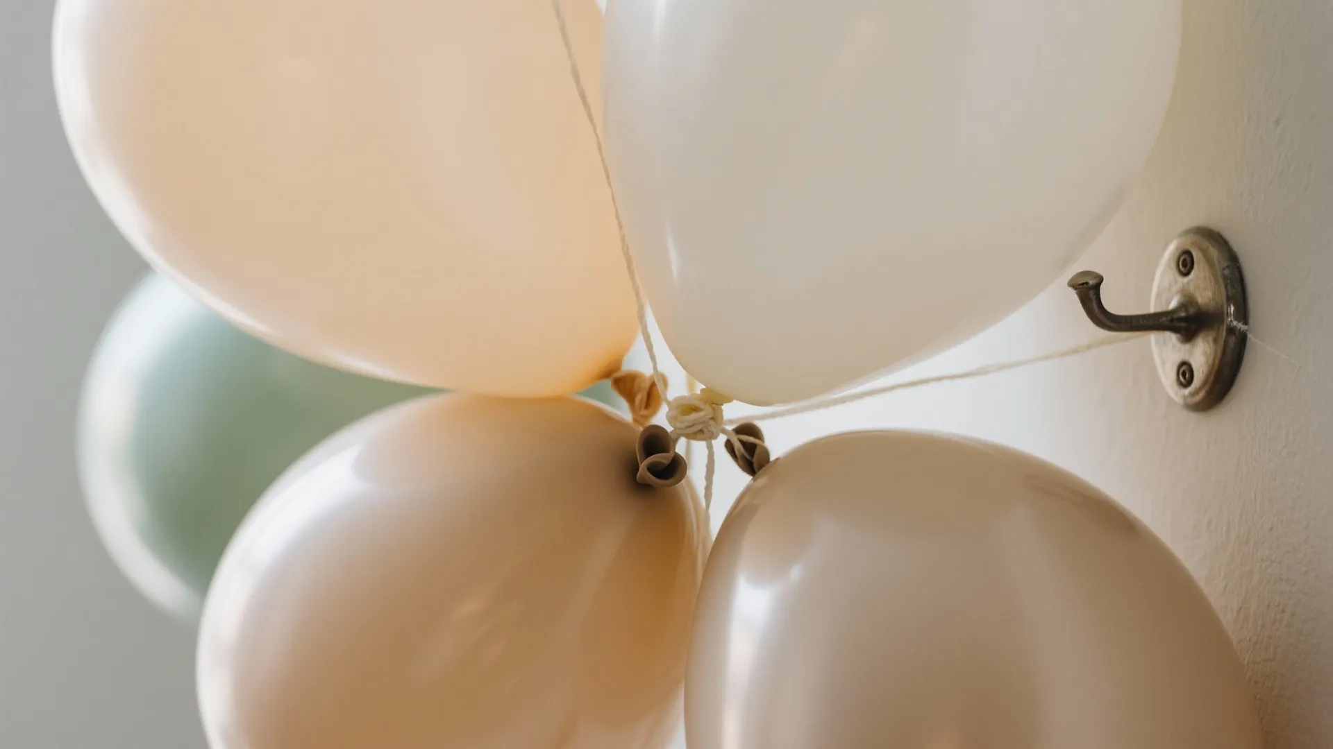 Soft Neutral Balloon Garland Over the Sofa