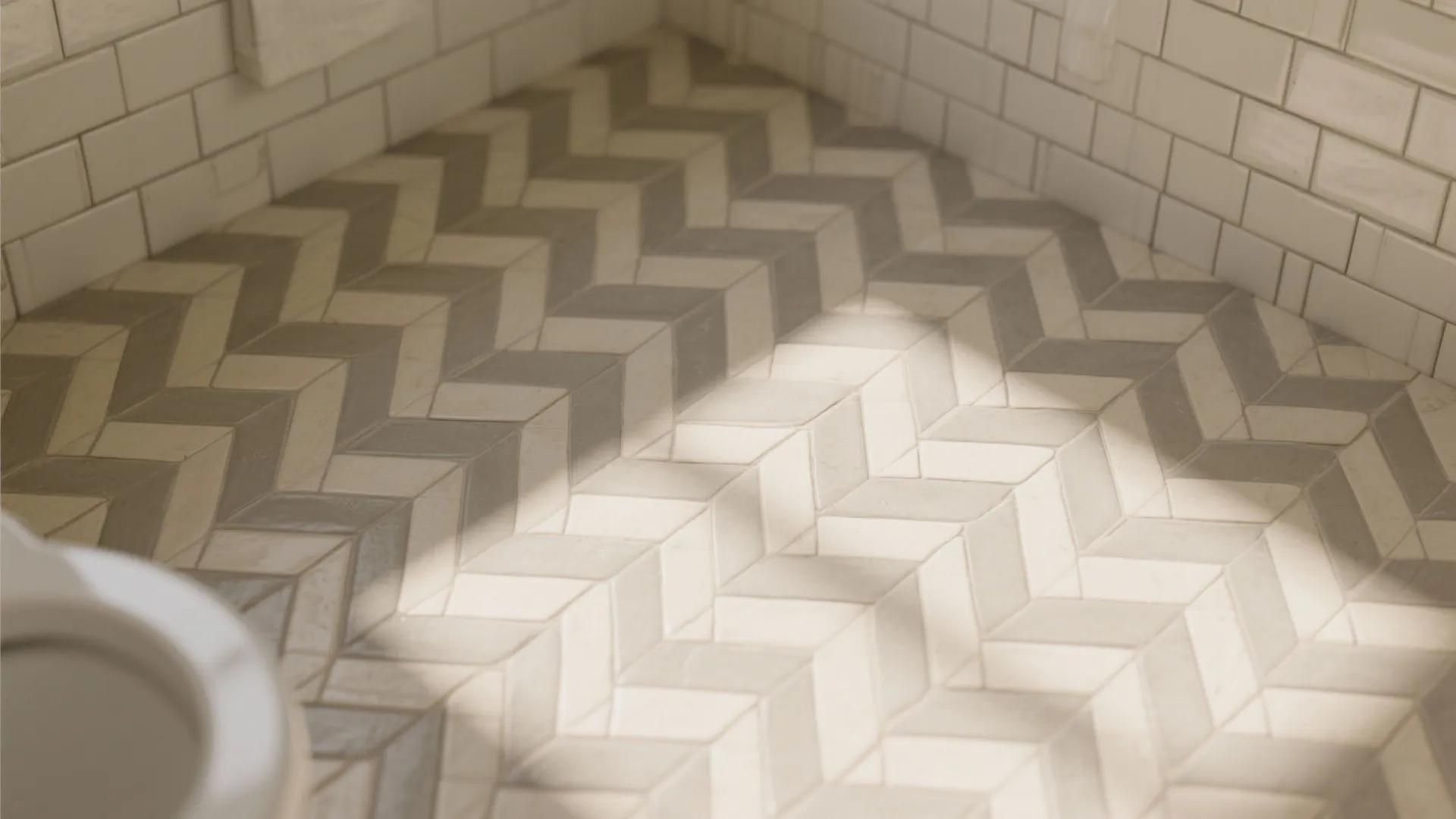Neutral colored herringbone floor tiles in a bathroom with white wall tiles and natural light
