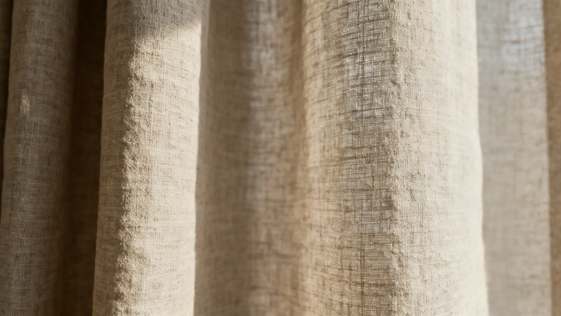 Neutral linen-blend curtain panel with visible slub texture under soft daylight.