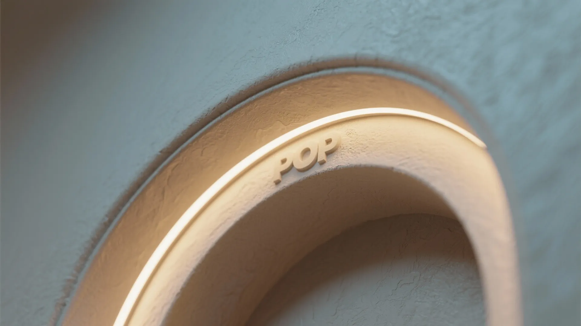 Close up of a circular wall arch with hidden warm light and the word pop