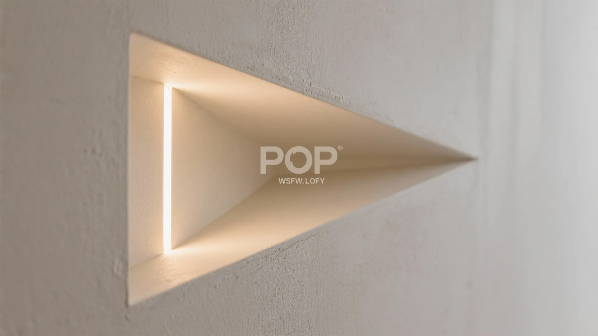 Close up of a triangle wall hole with warm light strip inside white textured wall