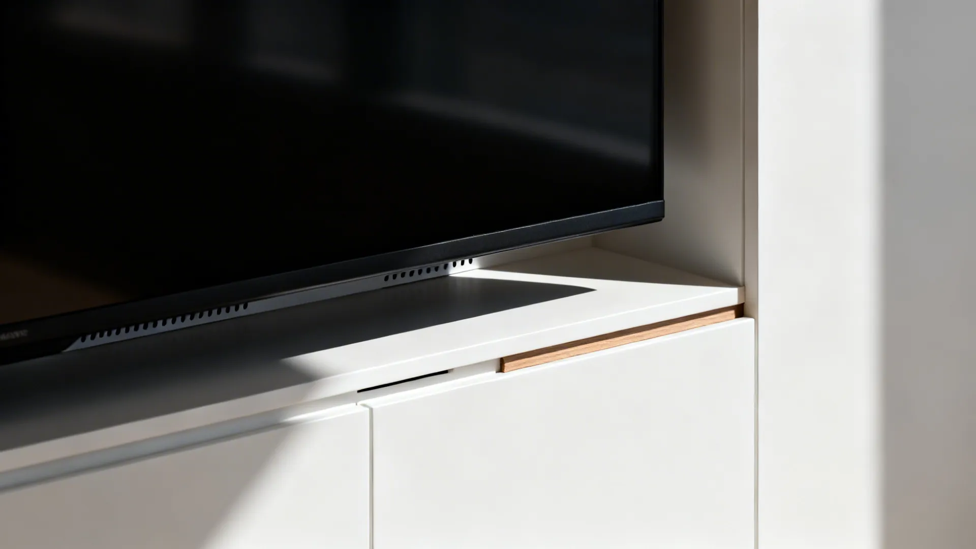 Macro of recessed TV niche edge with clean reveal and subtle ventilation gap.