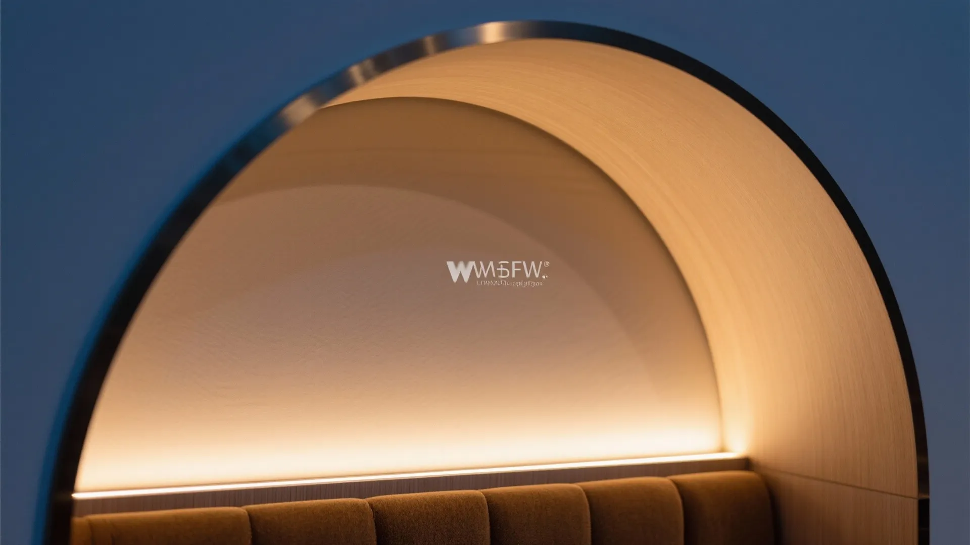 Macro detail of a warm LED strip along an arched niche intrados with clean laminate finish.