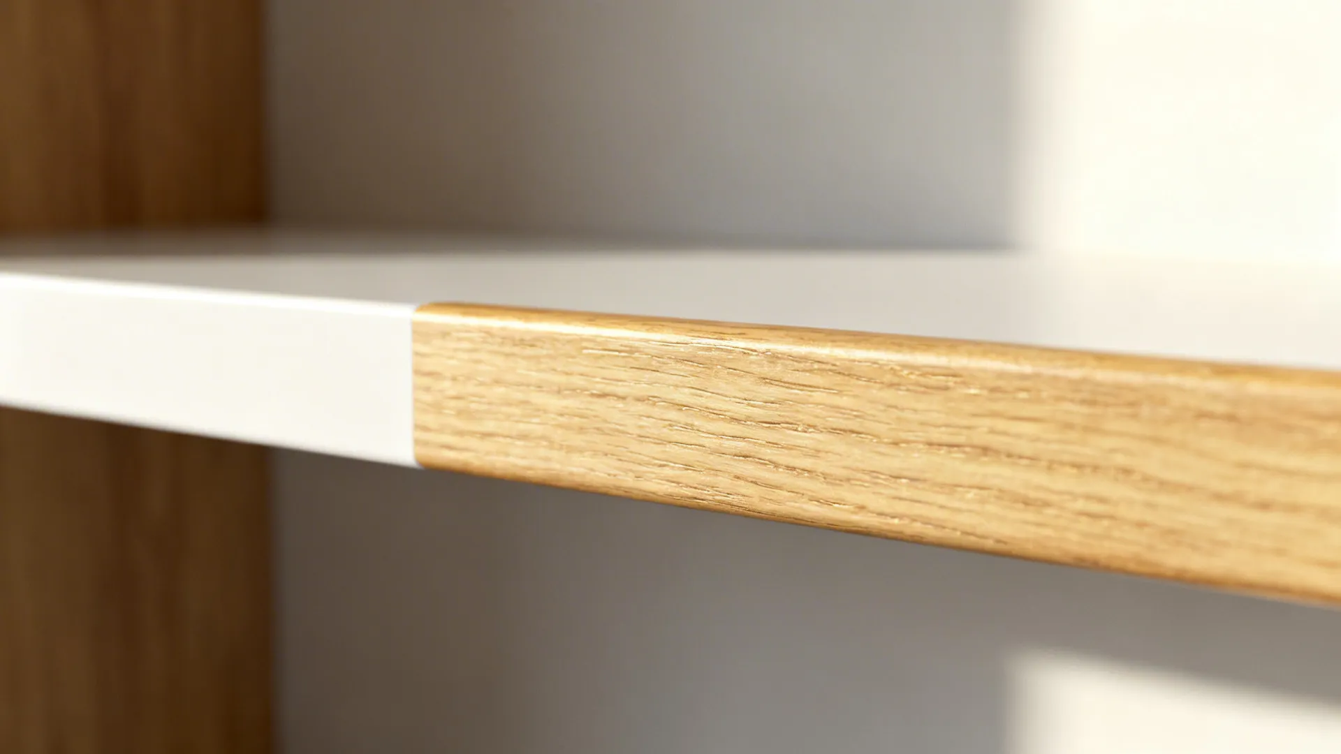 Close-up of pale oak edge detailing on a matte white kitchen shelf.